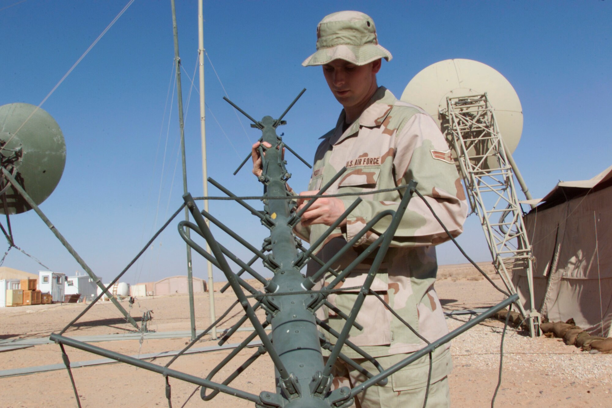 An Airman sets up an INMARSAT at Prince Sultan Air Base, Saudi Arabia.
