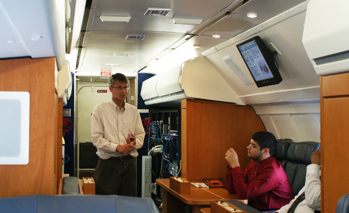 Men inside the fuselage simulator.