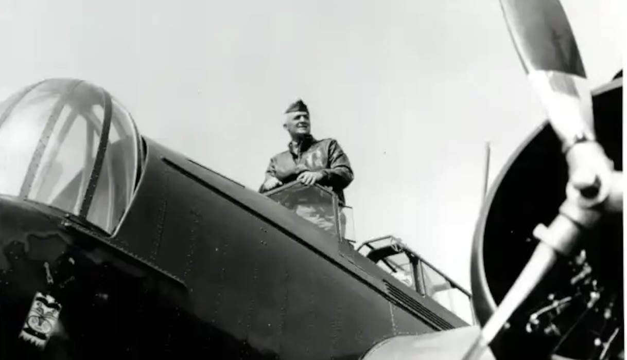 A man stands on a plane in 1934.