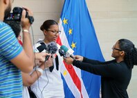 (March 20, 2023) Culinary Specialist Seaman Apprentice Erica Lopes, assigned to the guided missile destroyer USS Bulkley (DDG 84), speaks to members of the press about her childhood in Cabo Verde during the opening ceremony of the African Maritime Forces Summit (AMFS), Mar. 20 2023. Lopes, a Boston native, immigrated from Cabo Verde as a child and returned for the first time during AMFS. Hosted by NAVEUR-NAVAF, the AMFS is a strategic-level forum that brings African maritime and naval infantry leaders together with their international partners to address transnational maritime security challenges within African waters including the Atlantic Ocean, Indian Ocean, and Mediterranean Sea.