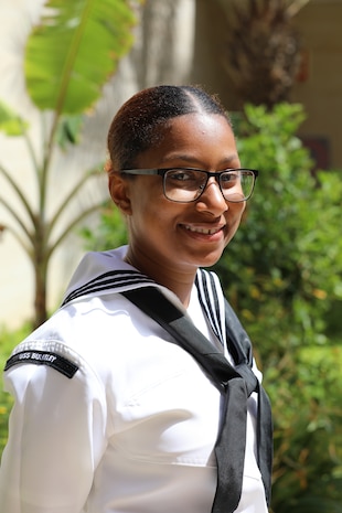 (March 20, 2023) Culinary Specialist Seaman Apprentice Erica Lopes, assigned to the guided missile destroyer USS Bulkley (DDG 84), poses for a photo following the opening ceremony of the African Maritime Forces Summit (AMFS), Mar. 20 2023. Lopes, a Boston native, immigrated from Cabo Verde as a child and returned for the first time during AMFS. Hosted by NAVEUR-NAVAF, the AMFS is a strategic-level forum that brings African maritime and naval infantry leaders together with their international partners to address transnational maritime security challenges within African waters including the Atlantic Ocean, Indian Ocean, and Mediterranean Sea.