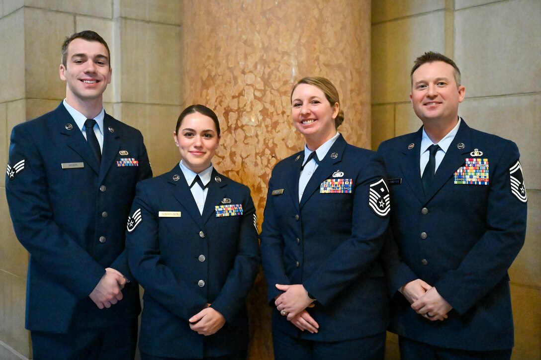 Senior Airman Corey Weber, Staff Sgt. Alica Bushhousen, Master Sgt. Crystal Puhalla and Senior Master Sgt. Nate Schmaderer, pose at the Nebraska State Capitol, Jan. 25, 2023 in Lincoln, Neb.