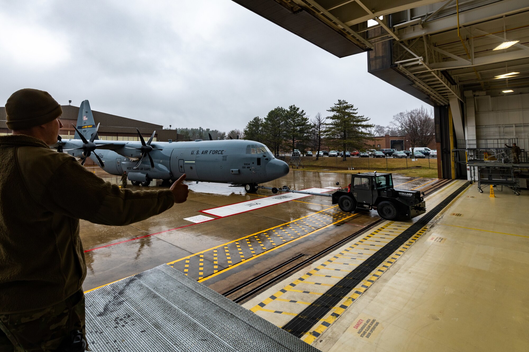 Reserve Citizen Airmen assigned to the 910th Maintenance Squadron tug a C-130J Super Hercules aircraft from the 130th Airlift Wing, McLaughlin Air National Guard Base, West Virginia, into an aircraft hangar at Youngstown Air Reserve Station, Ohio, on Feb. 22, 2023.