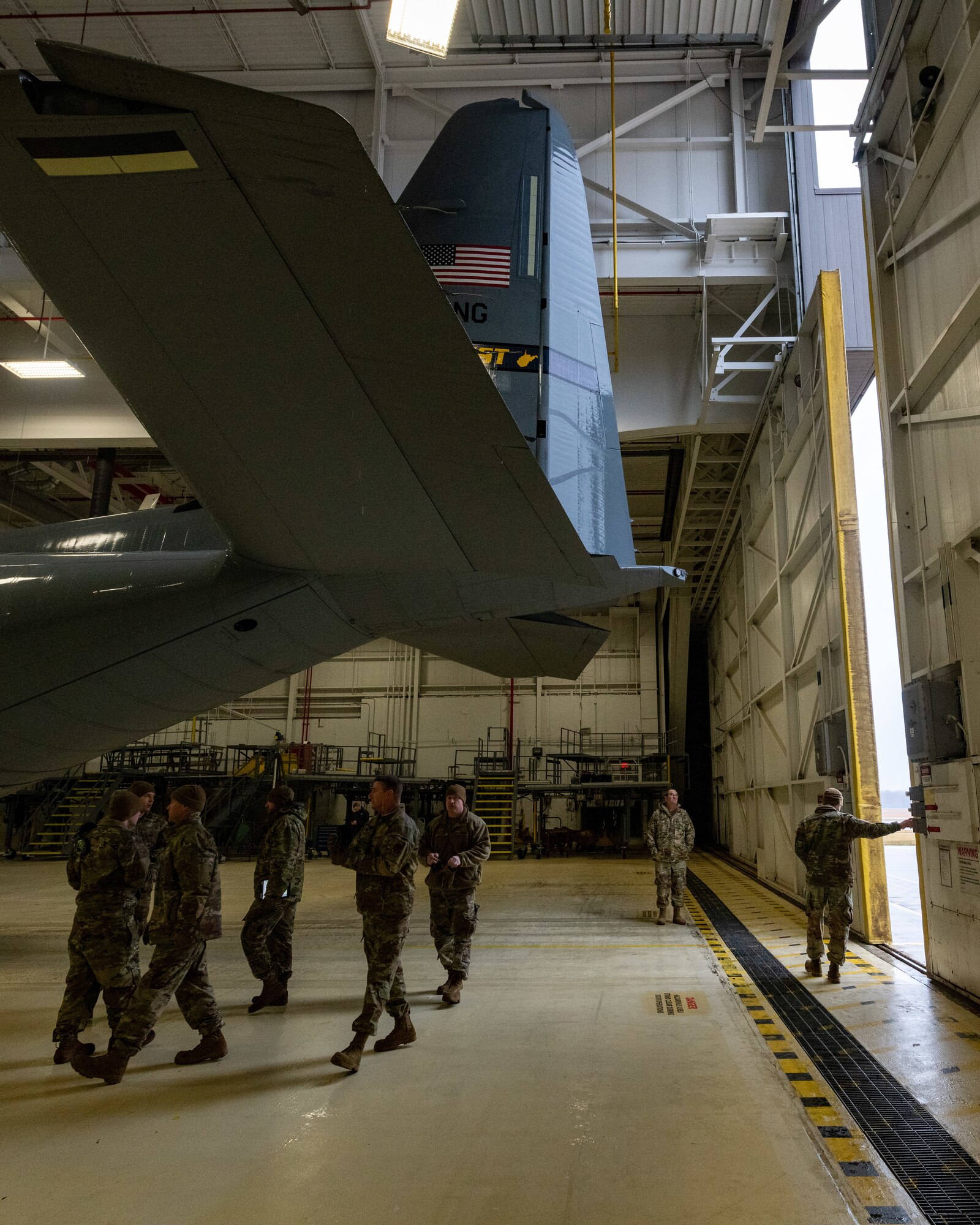 A Reserve Citizen Airman assigned to the 910th Maintenance Squadron closes an aircraft hangar door at Youngstown Air Reserve Station, Ohio, after tugging in a C-130J Super Hercules aircraft from the 130th Airlift Wing, McLaughlin Air National Guard Base, West Virginia, on Feb. 22, 2023.