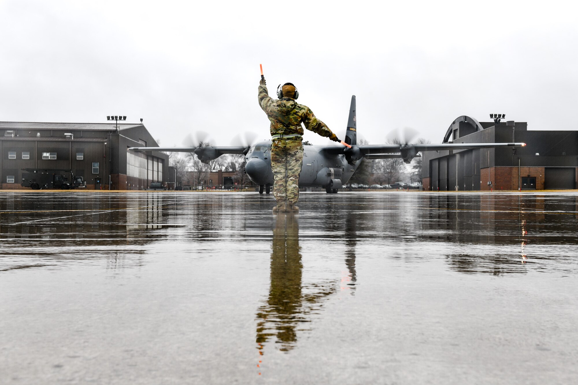 Senior Airman Danielle Clayton, an aerospace maintenance specialist with the 910th Aircraft Maintenance Squadron, marshals in a C-130J Super Hercules aircraft assigned to the 130th Airlift Wing, McLaughlin Air National Guard Base, West Virginia, on Feb. 22, 2023, at Youngstown Air Reserve Station, Ohio.