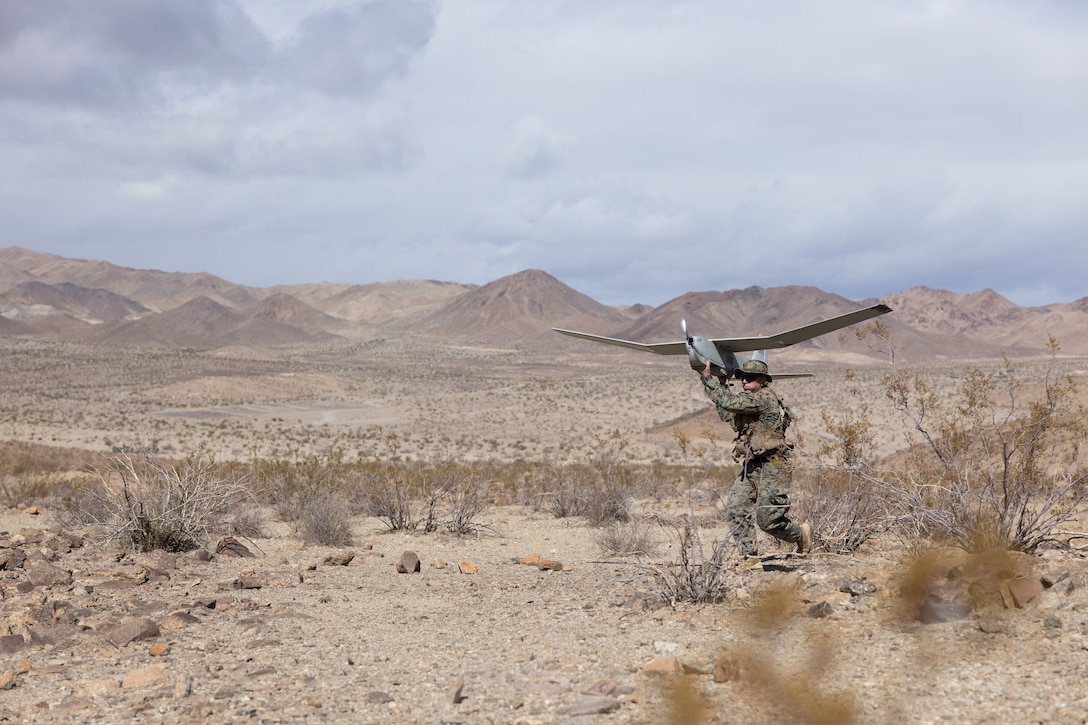 U.S. Marine Corps 1st Lt. Jacob Schultz, an intelligence officer with 3rd Battalion, 5th Marine Regiment, 1st Marine Division, launches an RQ-20 Puma unmanned aircraft system into flight during Marine Air-Ground Task Force Warfighting Exercise (MWX) 2-23, at Marine Corps Air Ground Combat Center, Twentynine Palms, California, Feb. 23, 2022. MWX is the culminating event of Service Level Training Exercise 2-23, that improves U.S. and allied service members’ operational capabilities. (U.S. Marine Corps photo by Cpl. Andrew Bray)