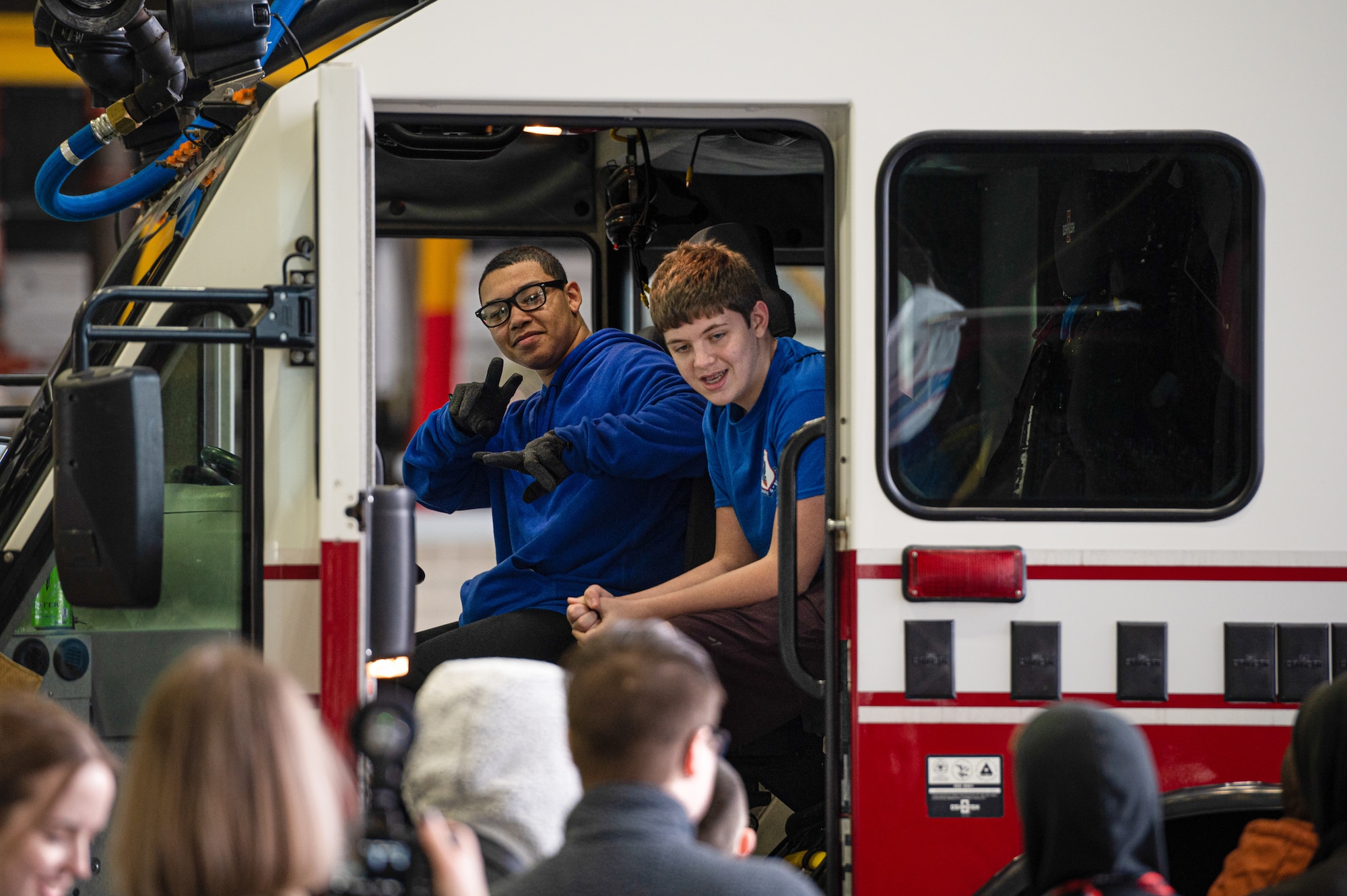 Cadets sit in a fire truck.