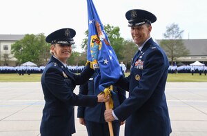 U.S. Air Force Maj. Gen. Michele Edmondson, Second Air Force commander, passes the guidon to Col. Billy Pope, 81st Training Wing commander, during an assumption of command ceremony on the Levitow Training Support Facility drill pad at Keesler Air Force Base, Mississippi, March 23, 2023.