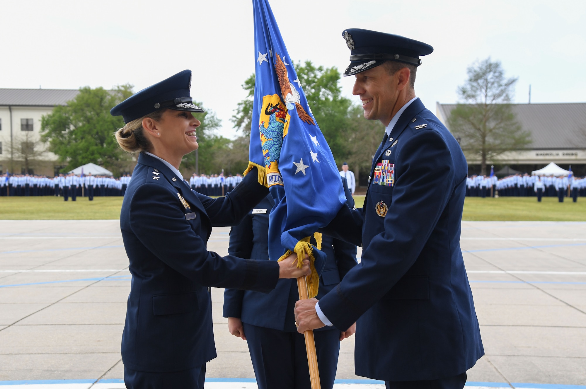 U.S. Air Force Maj. Gen. Michele Edmondson, Second Air Force commander, passes the guidon to Col. Billy Pope, 81st Training Wing commander, during an assumption of command ceremony on the Levitow Training Support Facility drill pad at Keesler Air Force Base, Mississippi, March 23, 2023.