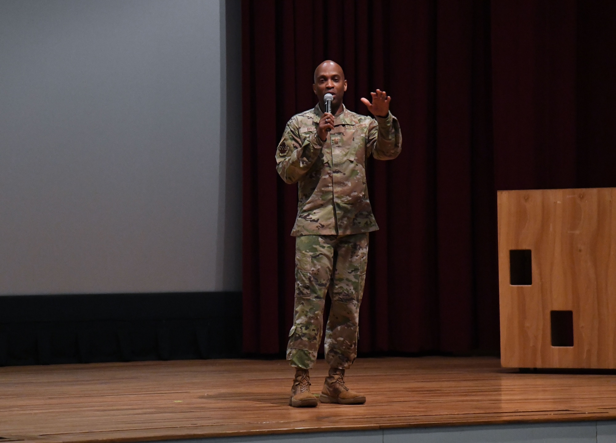 U.S. Air Force Chief Master Sgt. Keith Bruce, 16th Air Force command chief, delivers remarks to cyber students during an all call inside the Welch Theater at Keesler Air Force Base, Mississippi, March 22, 2023.