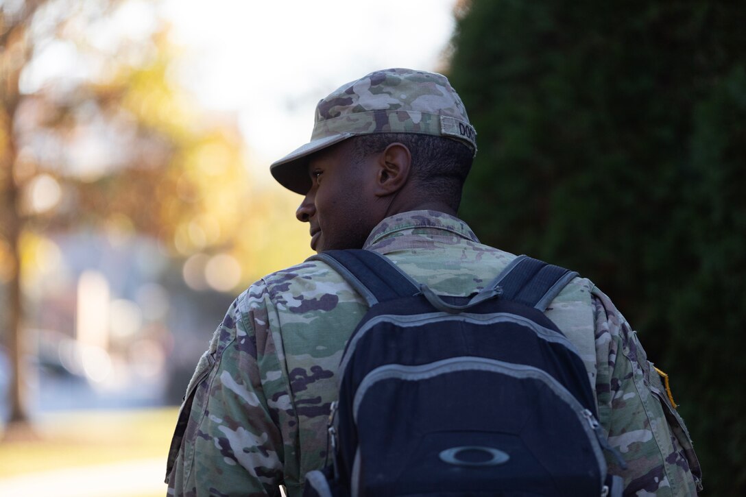 An ROTC Soldier attending Clemson University walks to class in uniform with a backpack, Nov. 18, 2022.