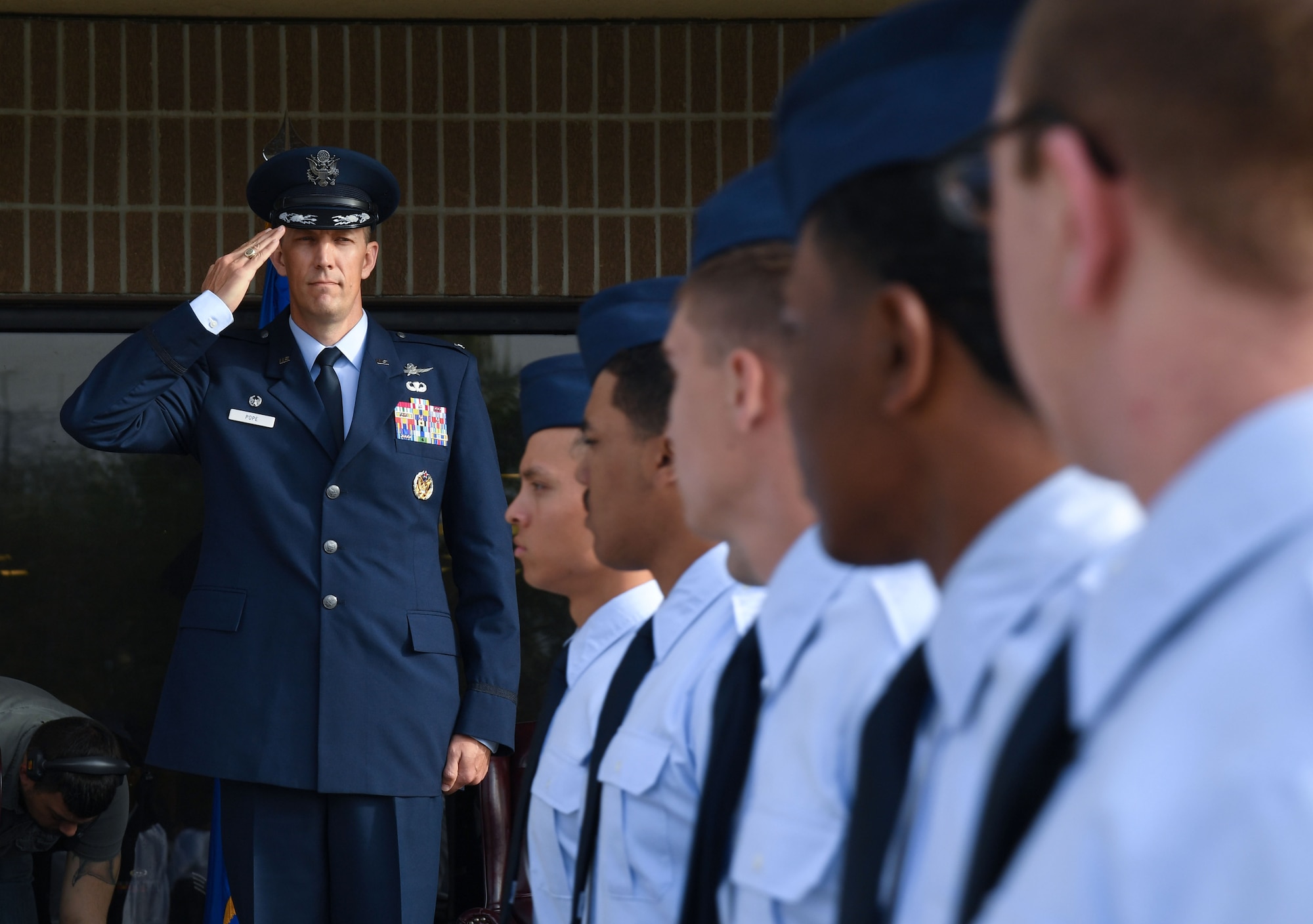 U.S. Air Force Col. Billy Pope, 81st Training Wing commander, renders a salute as Airmen pass in review during an assumption of command ceremony on the Levitow Training Support Facility drill pad at Keesler Air Force Base, Mississippi, March 23, 2023.