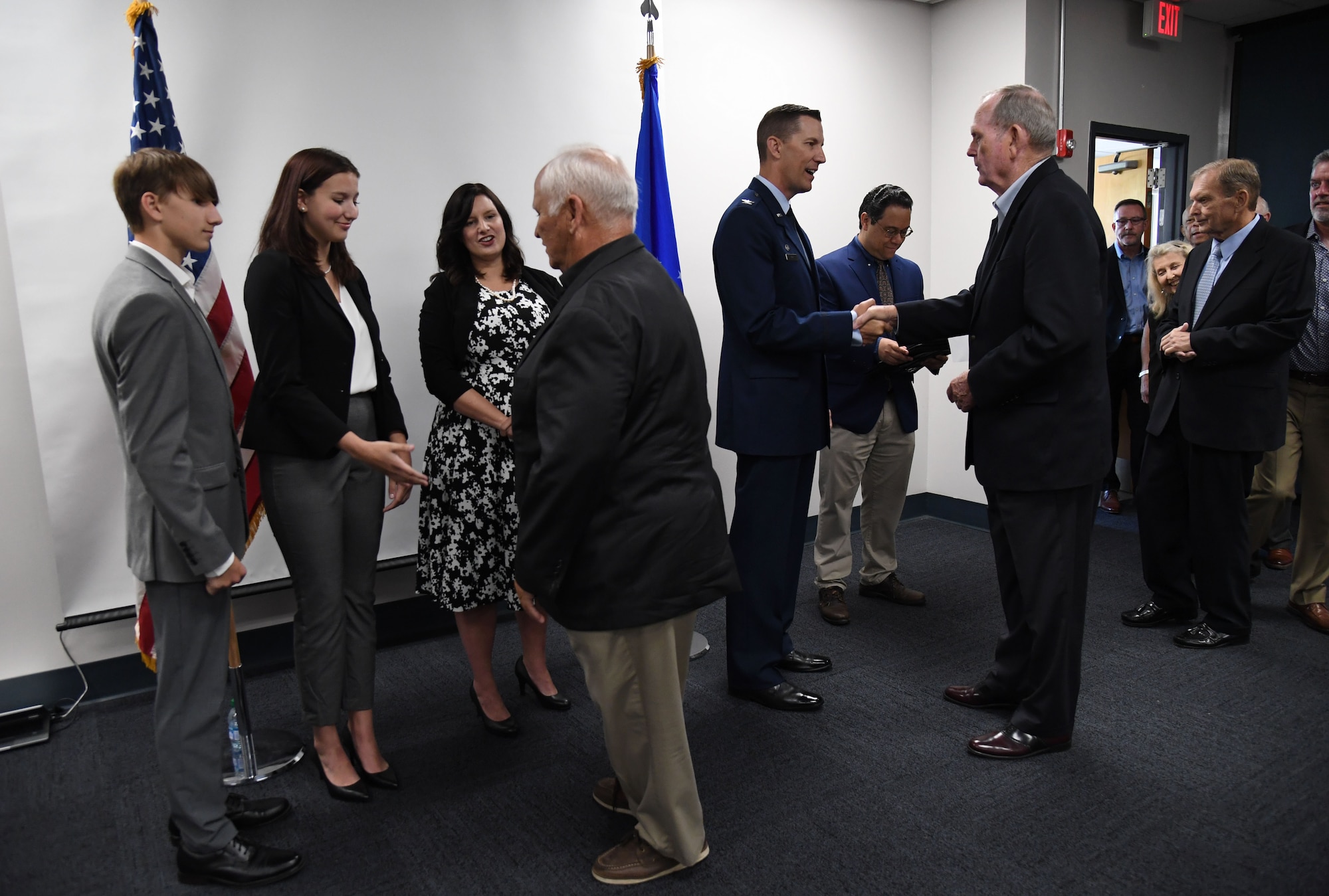 Retired Maj. Gen. John Maluda and retired Lt. Gen. Clark Griffith welcome U.S. Air Force Col. Billy Pope, 81st Training Wing commander, and his family during an assumption of command ceremony at the Levitow Training Support Facility at Keesler Air Force Base, Mississippi, March 23, 2023.