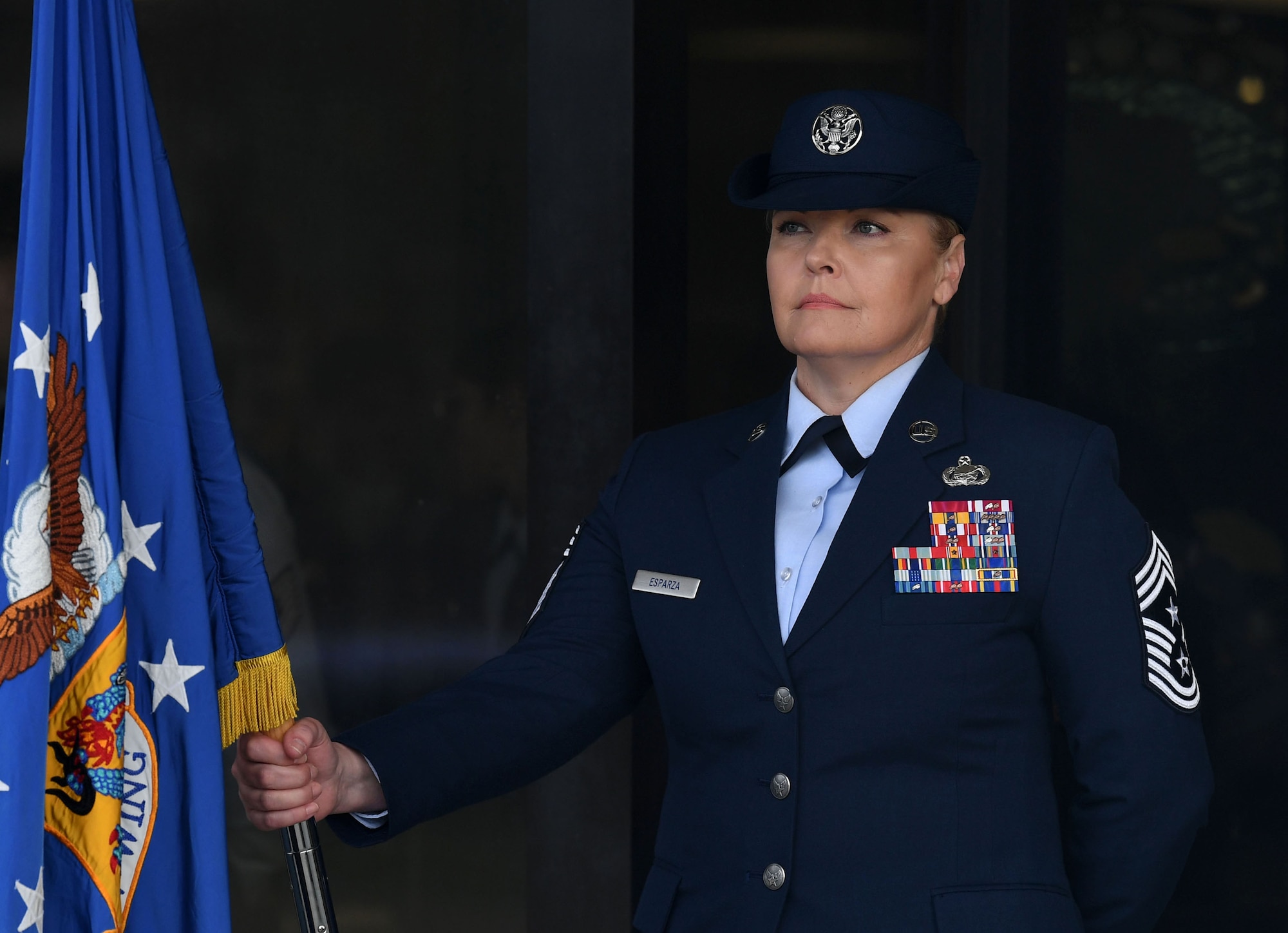 U.S. Air Force Chief Master Sgt. Sarah Esparza, 81st Training Wing command chief, holds the guidon during the 81st TRW assumption of command ceremony on the Levitow Training Support Facility drill pad at Keesler Air Force Base, Mississippi, March 23, 2023.