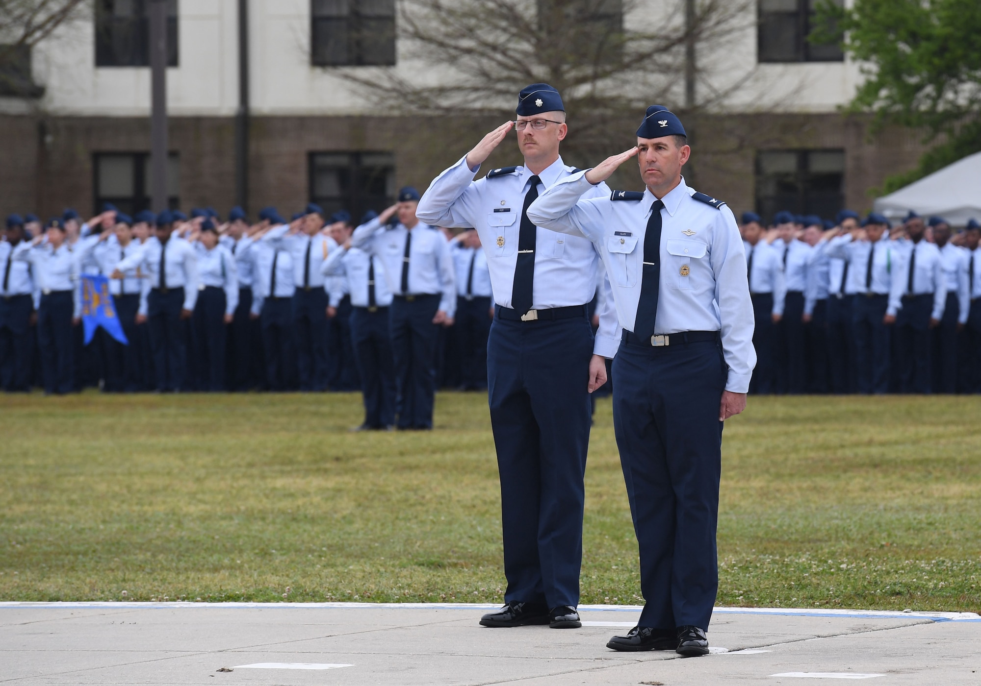 U.S. Air Force Lt. Col. Nicholas Kuc, 333rd Training Squadron commander, and Col. Jason Allen, 81st Training Wing vice commander, render salutes during the 81st TRW assumption of command ceremony on the Levitow Training Support Facility drill pad at Keesler Air Force Base, Mississippi, March 23, 2023.