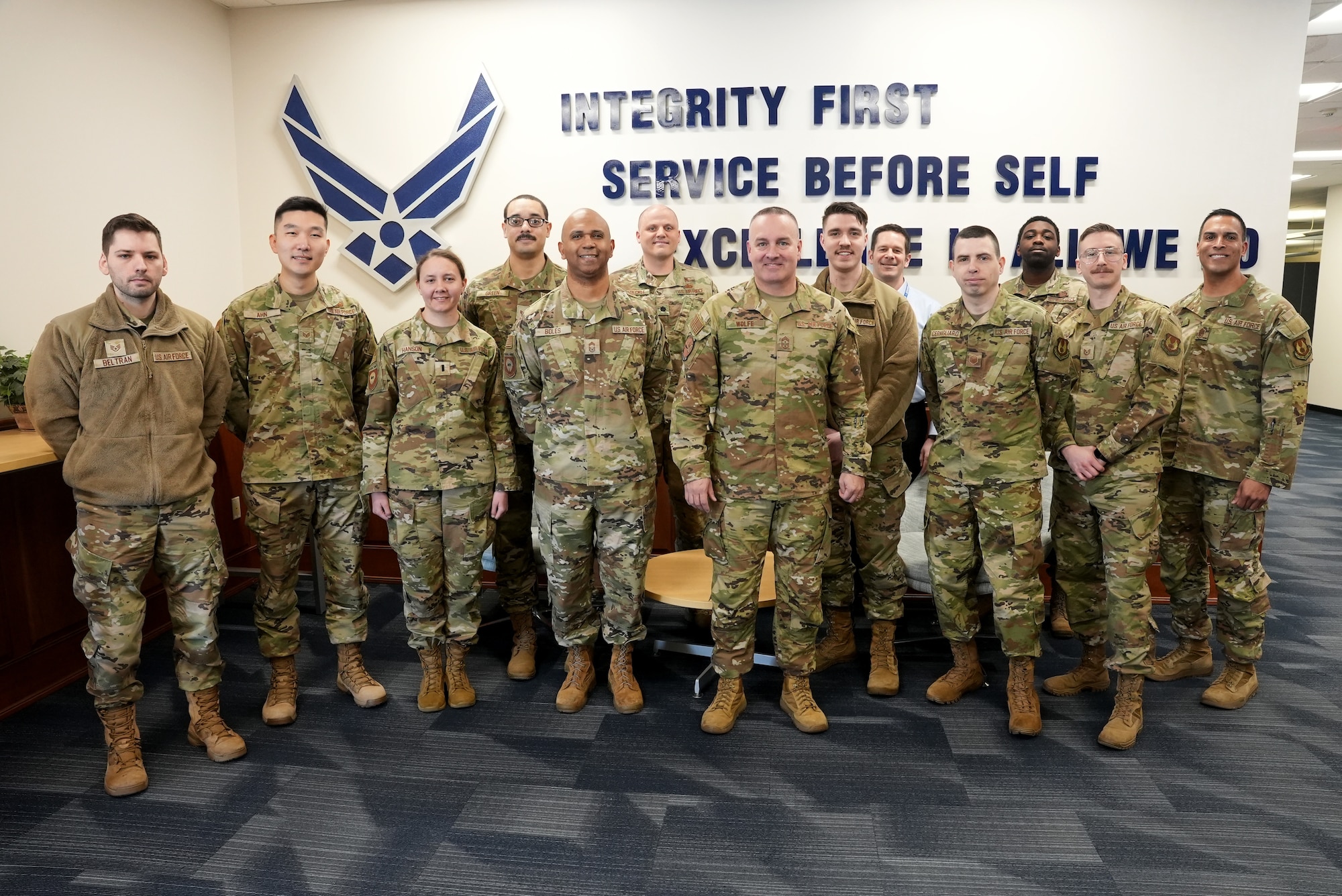 Chief Master Sergeants Kevin D. Boles, center left, and David R. Wolfe, center right, and Lt. Col. Jonathan Stueckle, rear center, pose for a photograph with Airmen at Kessel Run’s office here, March 20, 2023. Wolfe visited Kessel Run to educate Airmen on the current state of the Pacific Region and learn more about Kessel Run’s applications. Wolfe is the command chief master sergeant for Pacific Air Forces, Joint Base Pearl Harbor-Hickam, Hawaii. Boles is Kessel Run’s senior enlisted leader, while Stueckle is Kessel Run’s WingC2 product line chief. (U.S. Air Force photo by Richard Blumenstein)