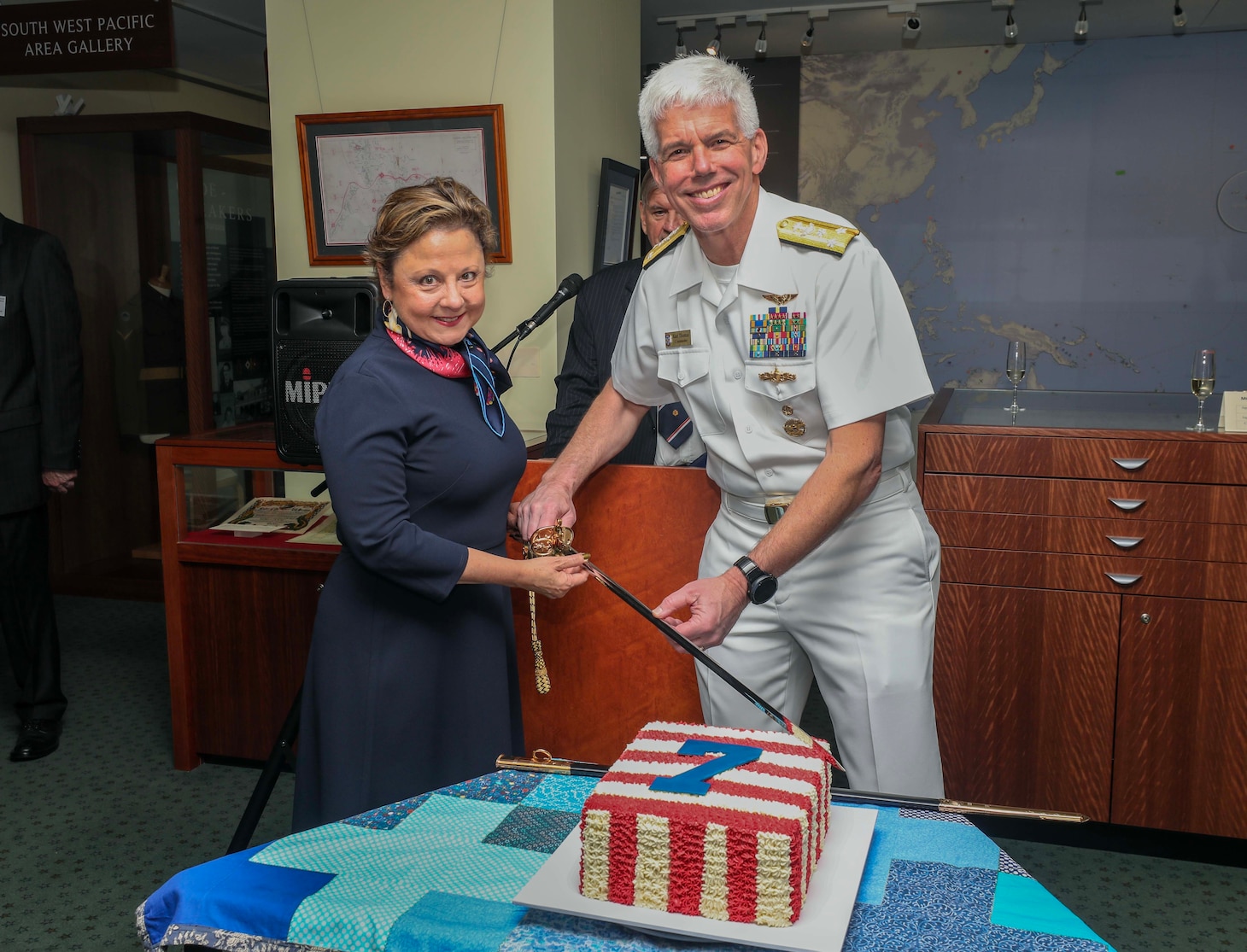 BRISBANE, Australia (March 15, 2023) – Vice Adm. Karl Thomas, commander, U.S. 7th Fleet, and Christine Elder, U.S. Consul General, pose for a cake cutting photo after a ceremony commemorating the 80th anniversary of the formation of the U.S. 7th Fleet at the Macarthur Museum in Brisbane, Australia, March 15. 7th Fleet is the U.S. Navy's largest forward-deployed numbered fleet, and routinely interacts and operates with Allies and partners in preserving a free and open Indo-Pacific region. (U.S. Navy photo by Mass Communication Specialist 1st Class Deanna C. Gonzales)