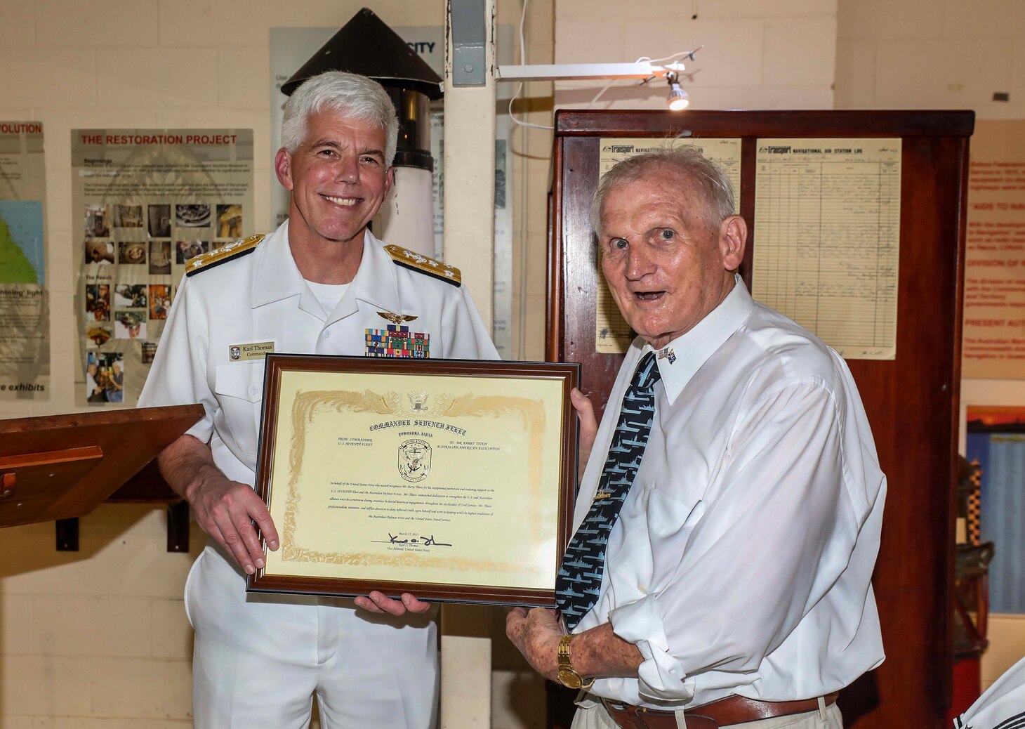 BRISBANE, Australia (March 15, 2023) – Vice Adm. Karl Thomas, commander, U.S. 7th Fleet, presents Mr. Barry Thiess, president of the Coral Sea Commemorative Association, an award during a ceremony for the official opening of a display commemorating the 80th anniversary of the formation of the U.S. 7th Fleet at the Queensland Maritime Museum in Brisbane, Australia, March 15. 7th Fleet is the U.S. Navy's largest forward-deployed numbered fleet, and routinely interacts and operates with Allies and partners in preserving a free and open Indo-Pacific region. (U.S. Navy photo by Mass Communication Specialist 1st Class Deanna C. Gonzales)
