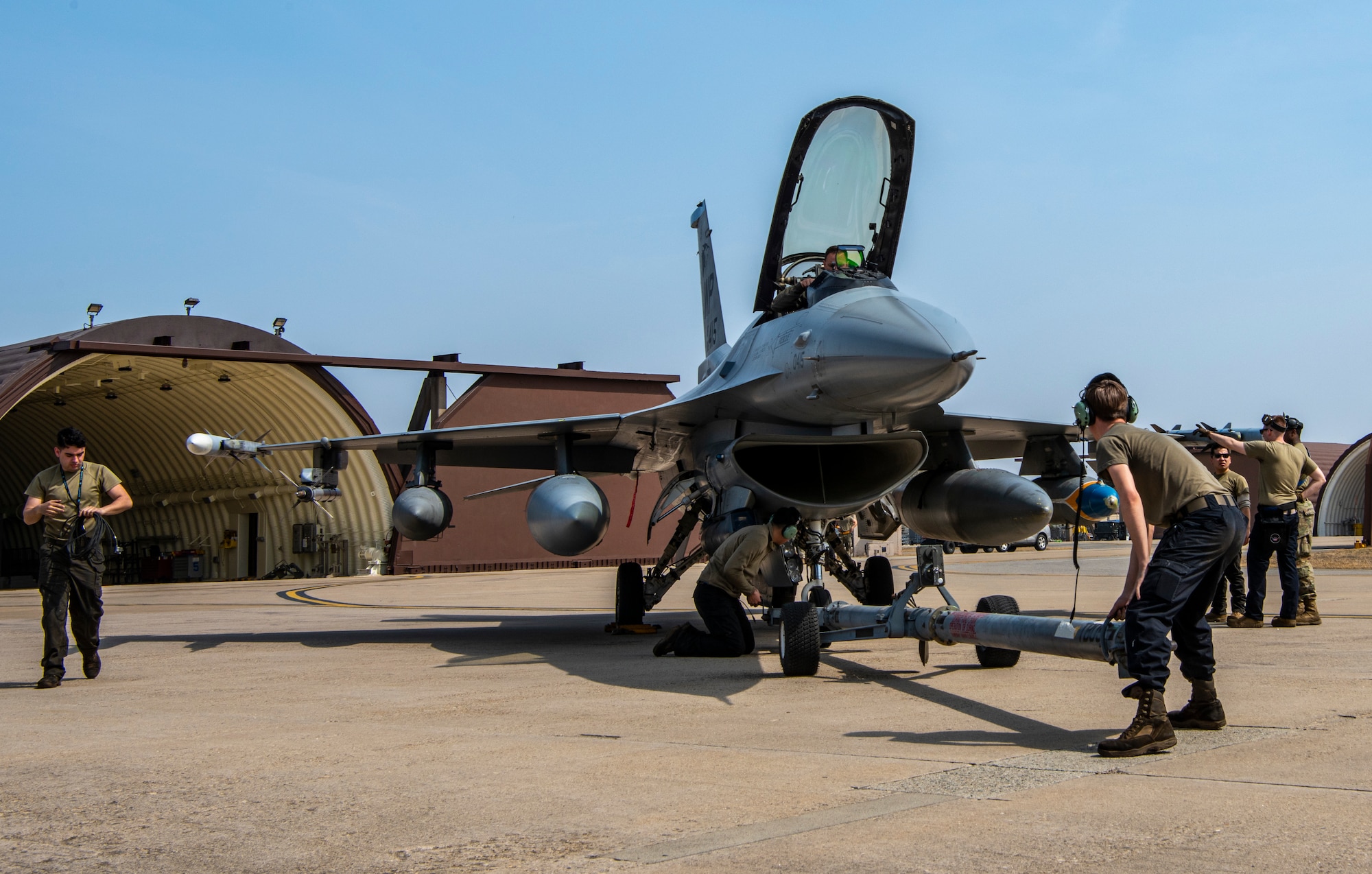 U.S. Air Force Airmen assigned to the 35th Fighter Generation Squadron, Kunsan Air Base, prepare to tow an F-16 Fighting Falcon at Osan AB, Republic of Korea, March 22, 2023.