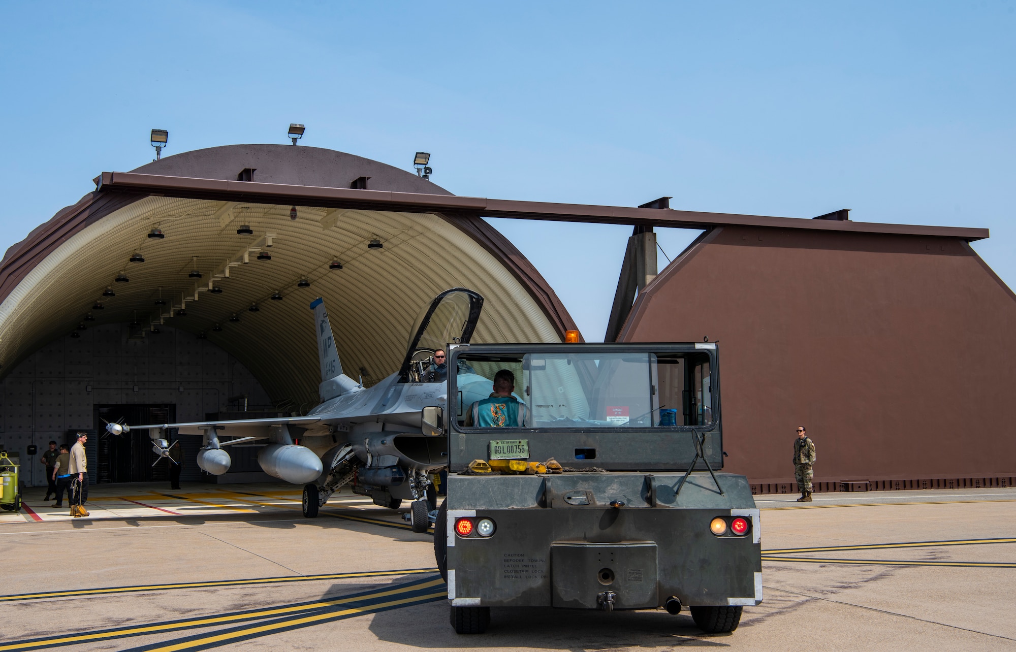 U.S. Air Force Airmen assigned to the 35th Fighter Generation Squadron, Kunsan Air Base, park an F-16 Fighting Falcon at Osan AB, Republic of Korea, March 22, 2023.