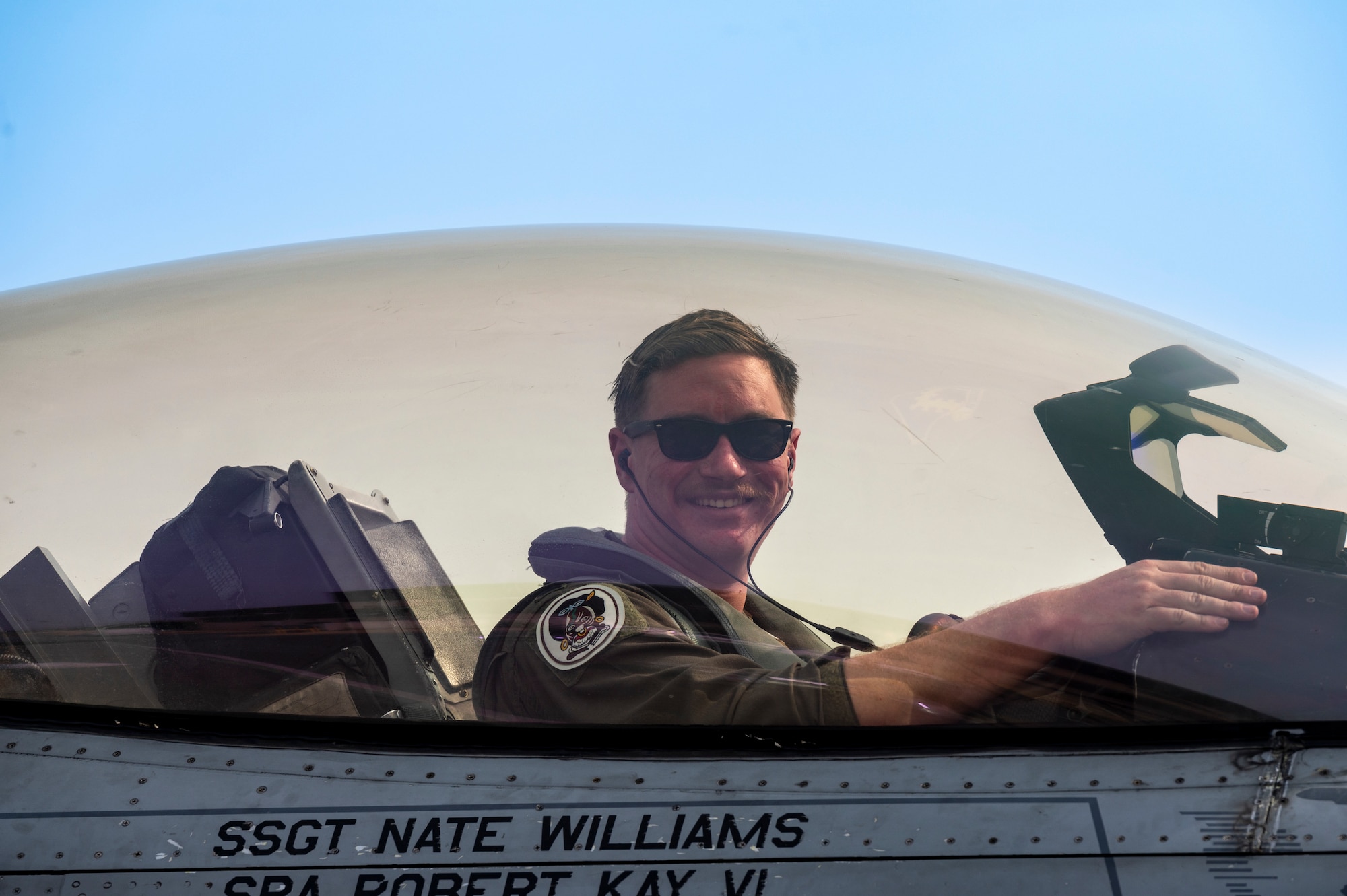 U.S. Air Force 1st Lt. Harry Butcher, 80th Fighter Squadron pilot, Kunsan Air Base, smiles for a photo in an F-16 Fighting Falcon at Osan AB, Republic of Korea, March 22, 2023.