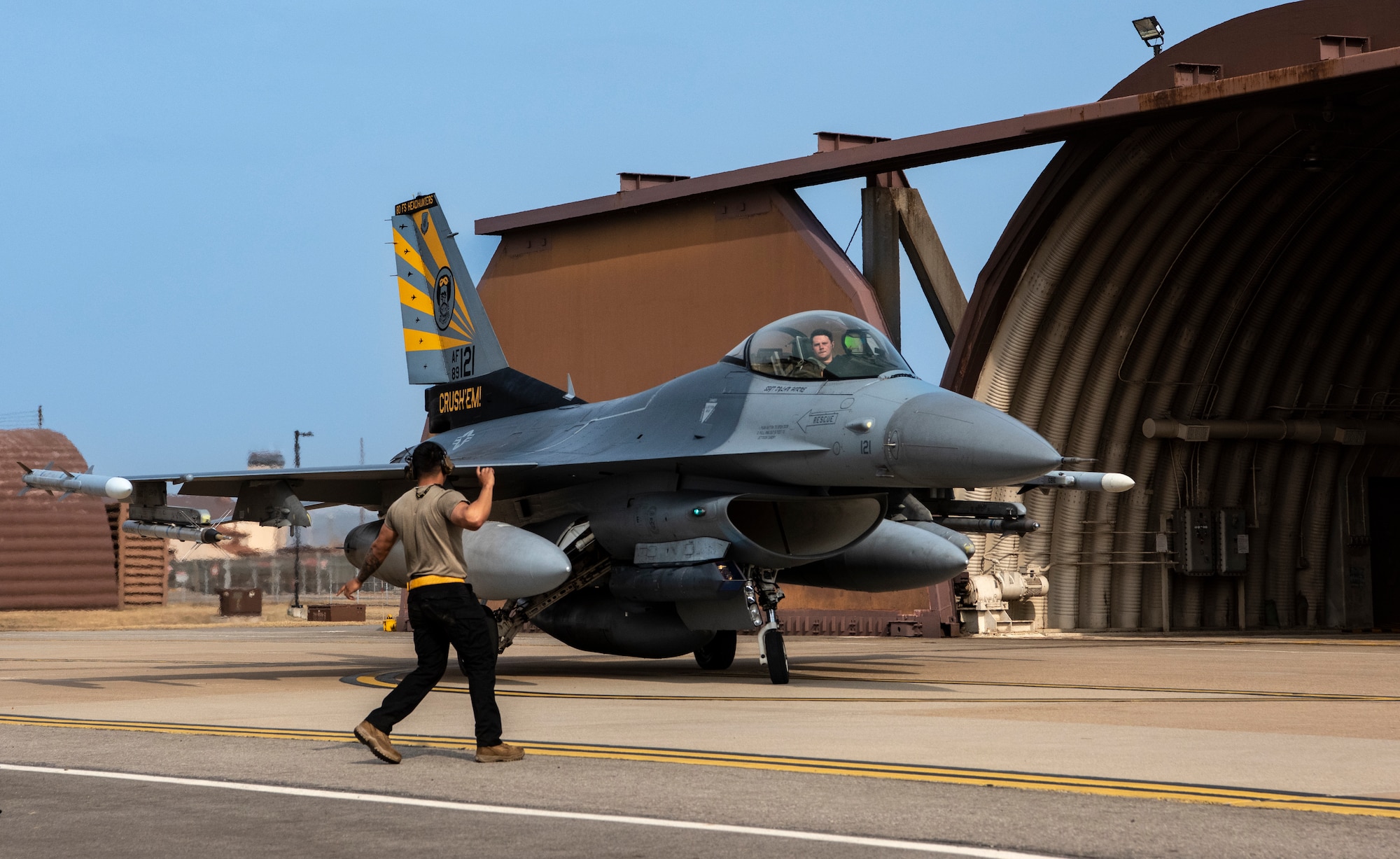 U.S. Air Force Senior Airman Martin Alvarado, 80th Fighter Generation Squadron crew chief, Kunsan Air Base, marshals an F-16 Fighting Falcon at Osan AB, Republic of Korea, March 22, 2023.