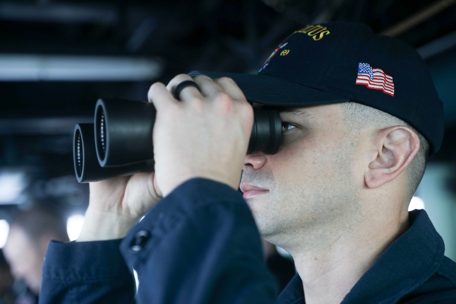 SOUTH CHINA SEA (March 24, 2023) – Lt. j.g. Stephan Arcieri, from Atlanta, stands watch on the bridge aboard the Arleigh Burke-class guided-missile destroyer USS Milius (DDG 69) while conducting a freedom of navigation operation in the South China Sea, March 24. Milius is forward-deployed to the U.S. 7th Fleet area of operations in support of a free and open Indo-Pacific. (U.S. Navy photo by Mass Communication Specialist 1st Class Greg Johnson)