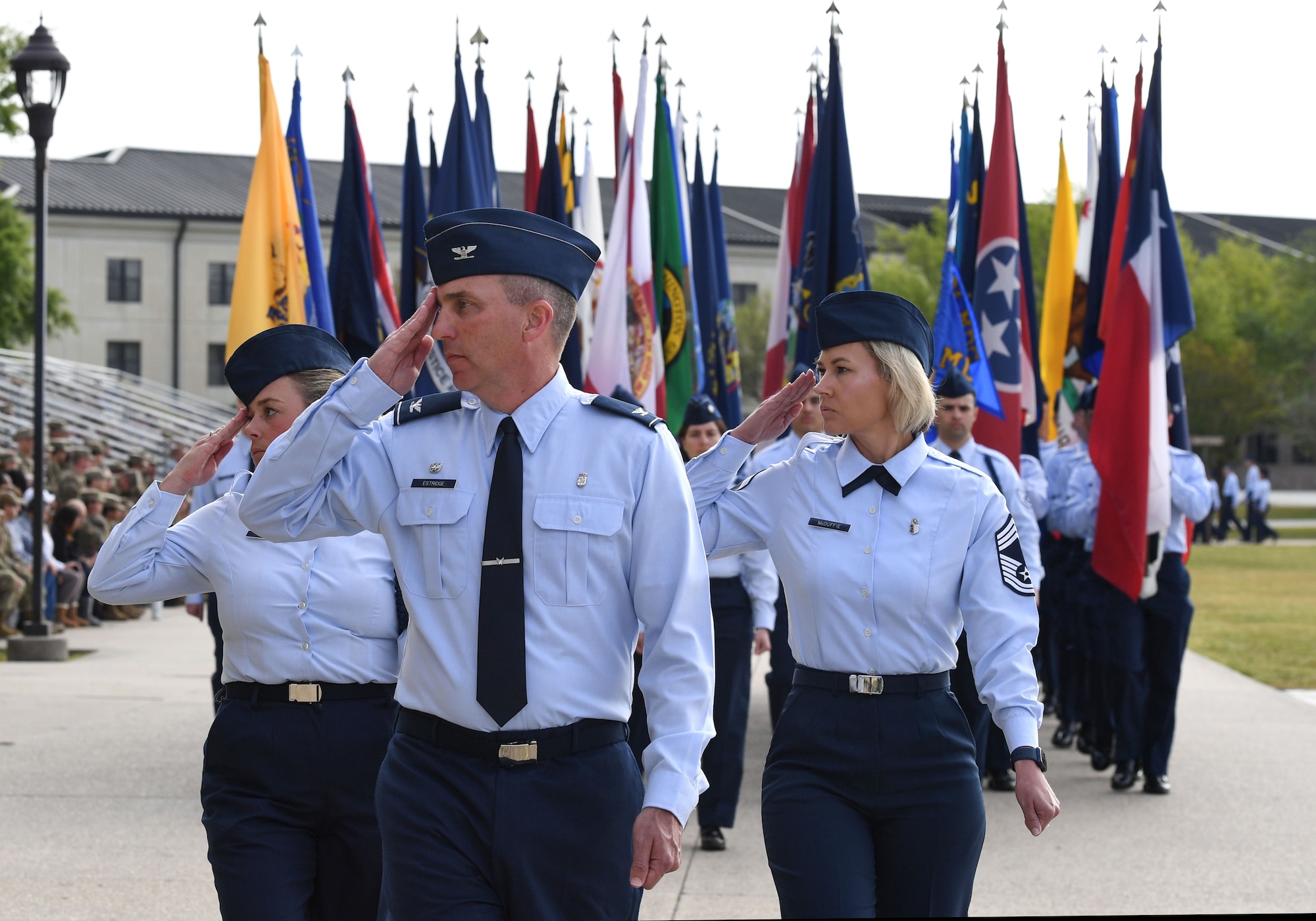 U.S. Air Force Col. Christopher Estridge, 81st Medical Group commander, Tech. Sgt. Madeline Whiton, 336th Training Squadron military training leader, and Chief Master Sgt. Jacey McDuffie, 81st MDG senior enlisted leader, march in formation during the 81st Training Wing assumption of command ceremony on the Levitow Training Support Facility drill pad at Keesler Air Force Base, Mississippi, March 23, 2023.