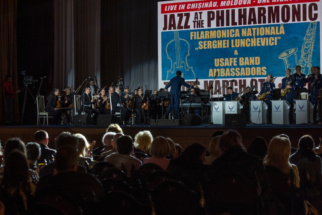 U.S. Air Force Airmen assigned to the U.S. Air Forces in Europe regional band and members of the Moldovan Philharmonic Orchestra perform together in Chisinau, Moldova, March 9, 2023. The USAFE band traveled to Moldova to celebrate the Martisor Festival, a cultural springtime festival celebrated during the month of March, with the people of Moldova. (U.S. Air Force photo by Airman 1st Class Madelyn Keech)