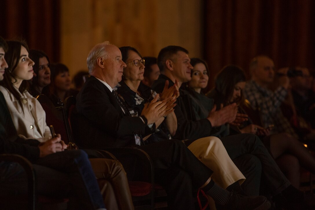 An audience listens to a band perform