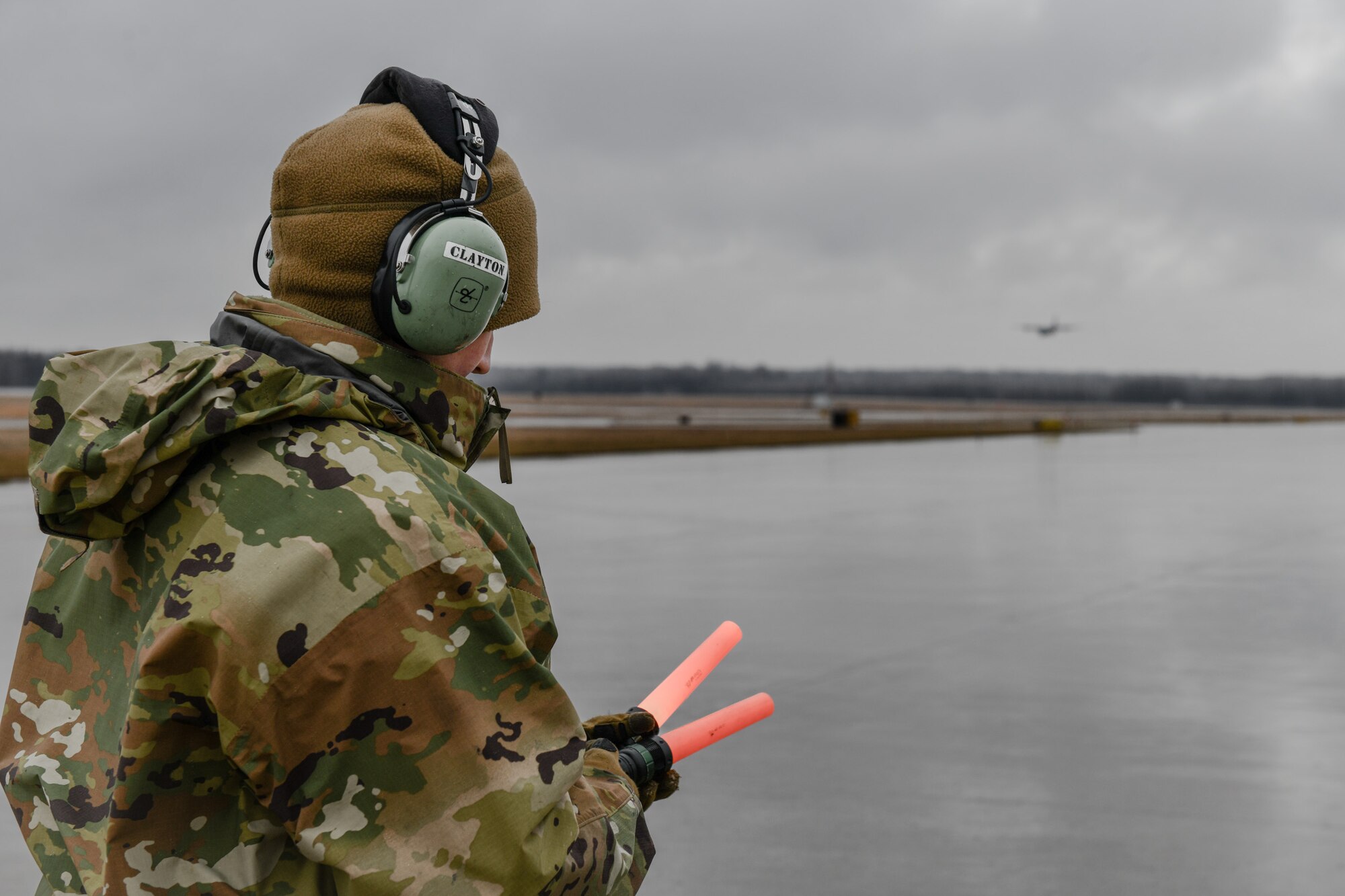 Senior Airman Danielle Clayton, an aerospace maintenance specialist with the 910th Aircraft Maintenance Squadron, waits to marshal in a C-130J Super Hercules aircraft assigned to the 130th Airlift Wing, McLaughlin Air National Guard Base, West Virginia, on Feb. 22, 2023, at Youngstown Air Reserve Station, Ohio.