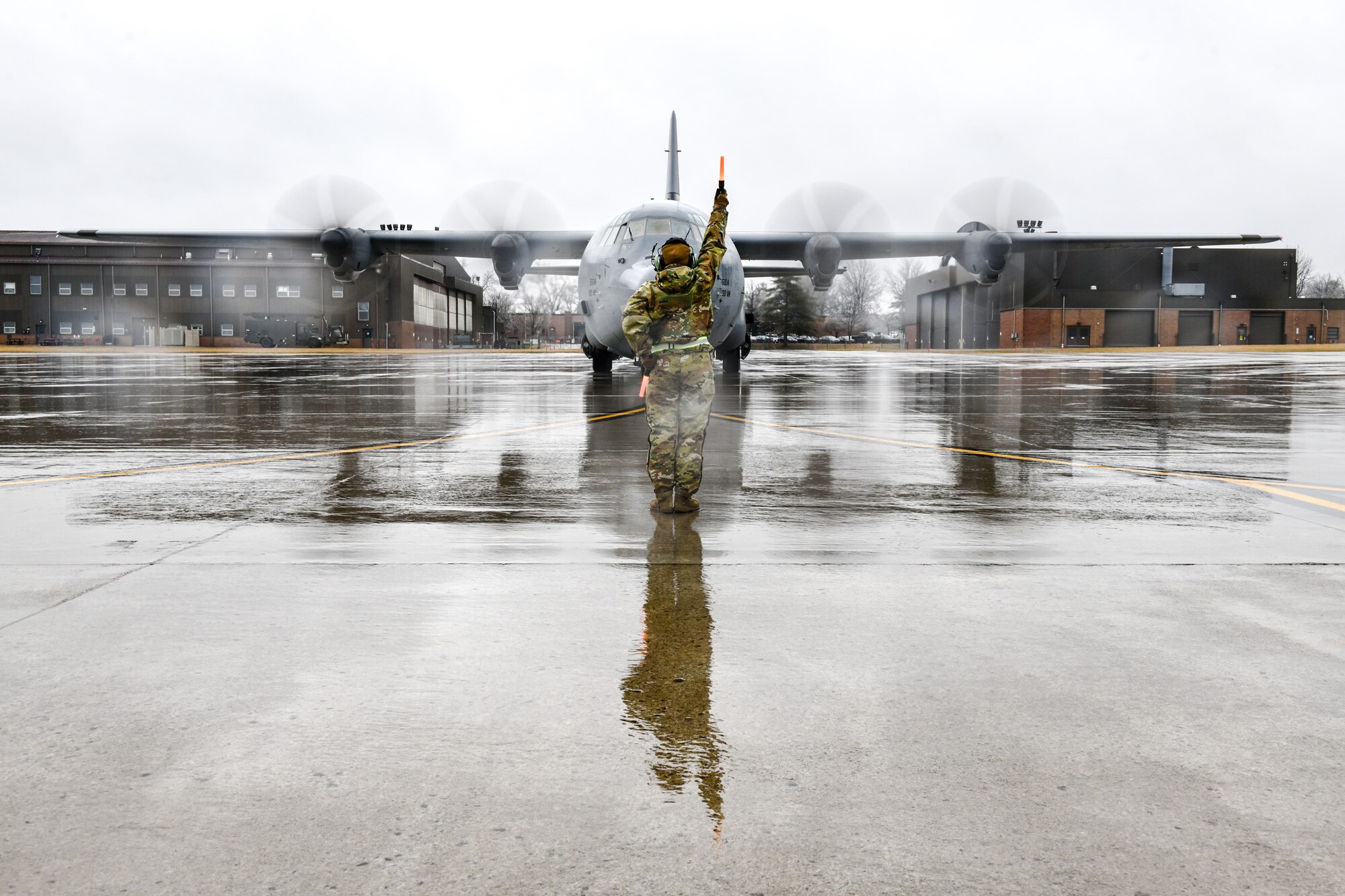 Senior Airman Danielle Clayton, an aerospace maintenance specialist with the 910th Aircraft Maintenance Squadron, marshals in a C-130J Super Hercules aircraft assigned to the 130th Airlift Wing, McLaughlin Air National Guard Base, West Virginia, on Feb. 22, 2023, at Youngstown Air Reserve Station, Ohio.