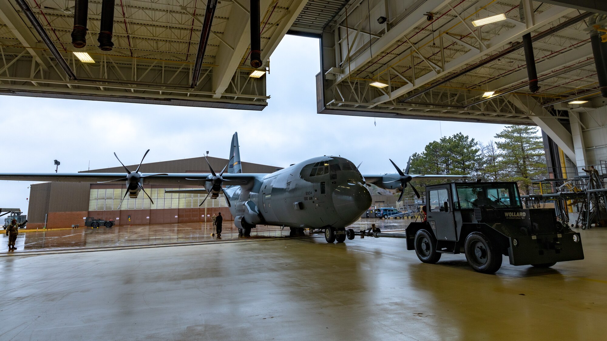 Reserve Citizen Airmen assigned to the 910th Maintenance Squadron tug a C-130J Super Hercules aircraft from the 130th Airlift Wing, McLaughlin Air National Guard Base, West Virginia, into an aircraft hangar at Youngstown Air Reserve Station, Ohio, on Feb. 22, 2023.