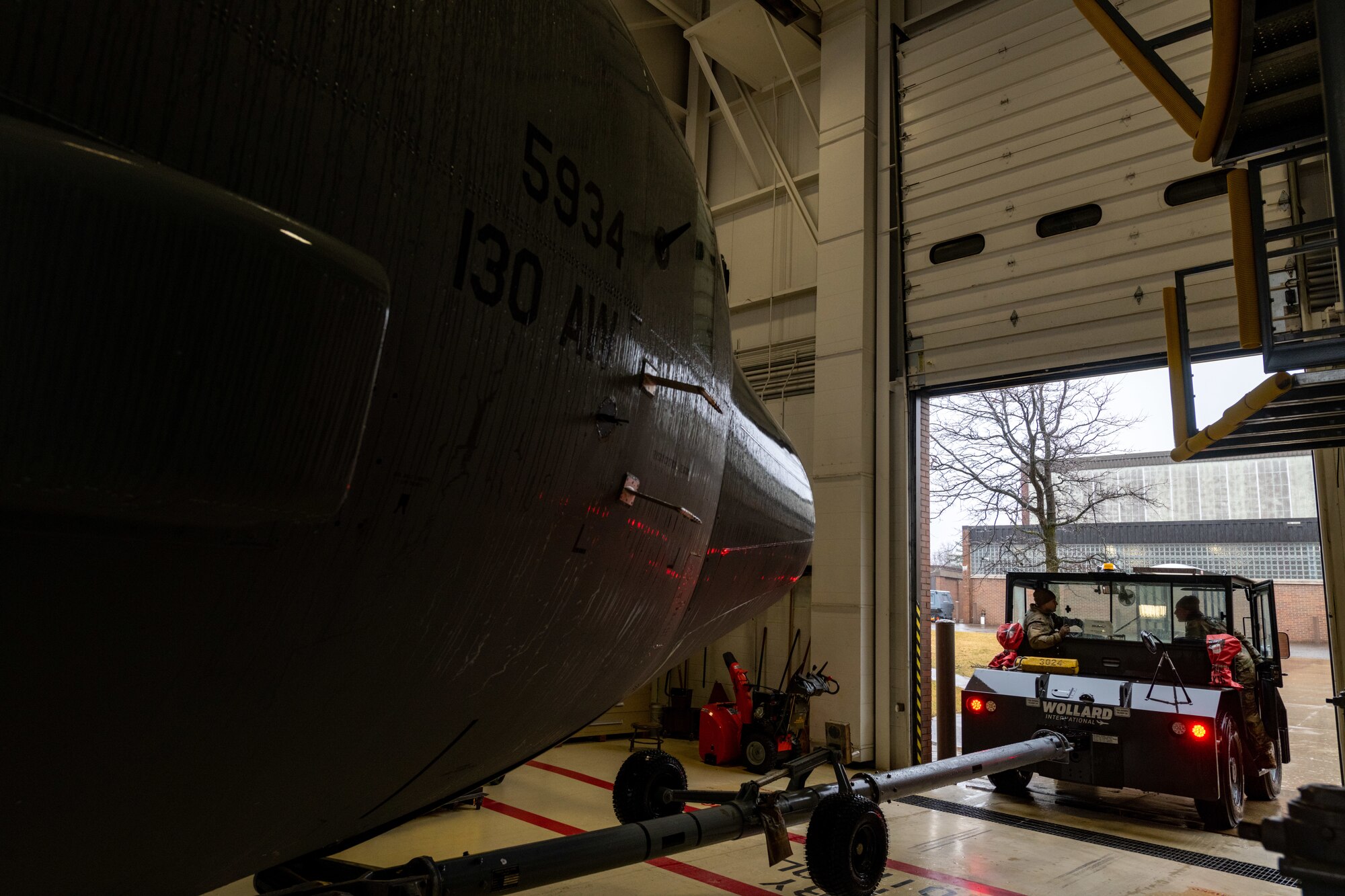 Reserve Citizen Airmen assigned to the 910th Maintenance Squadron tug a C-130J Super Hercules aircraft from the 130th Airlift Wing, McLaughlin Air National Guard Base, West Virginia, into an aircraft hangar at Youngstown Air Reserve Station, Ohio, on Feb. 22, 2023.