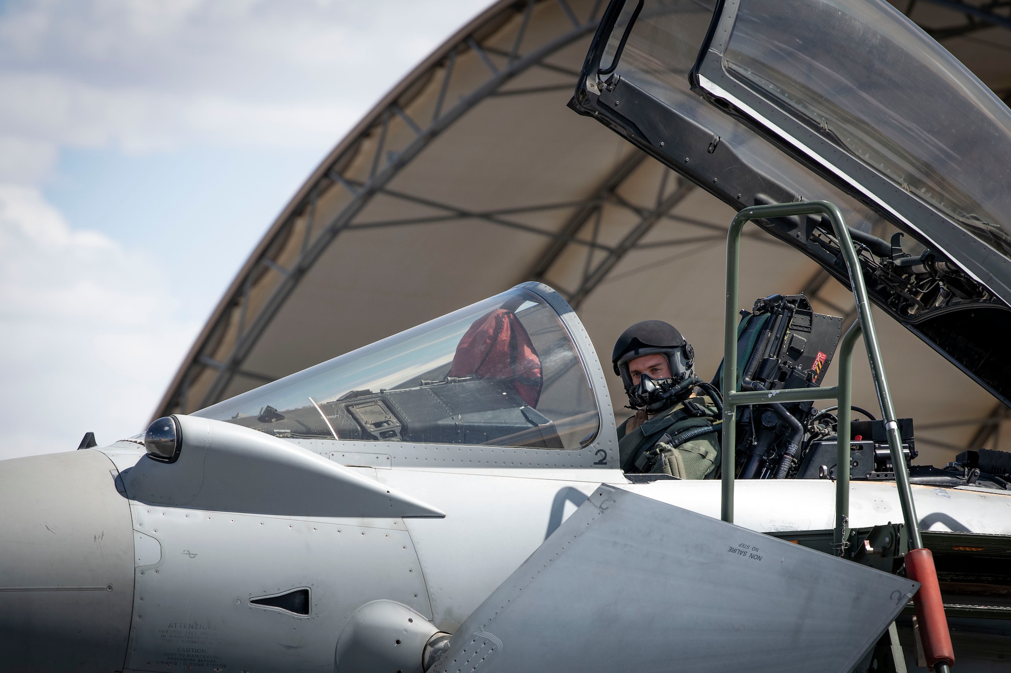 An Italian pilot waits for his portion of a demonstration to start during Media Day at Ali Al Salem Air Base, Kuwait, March 21, 2023.