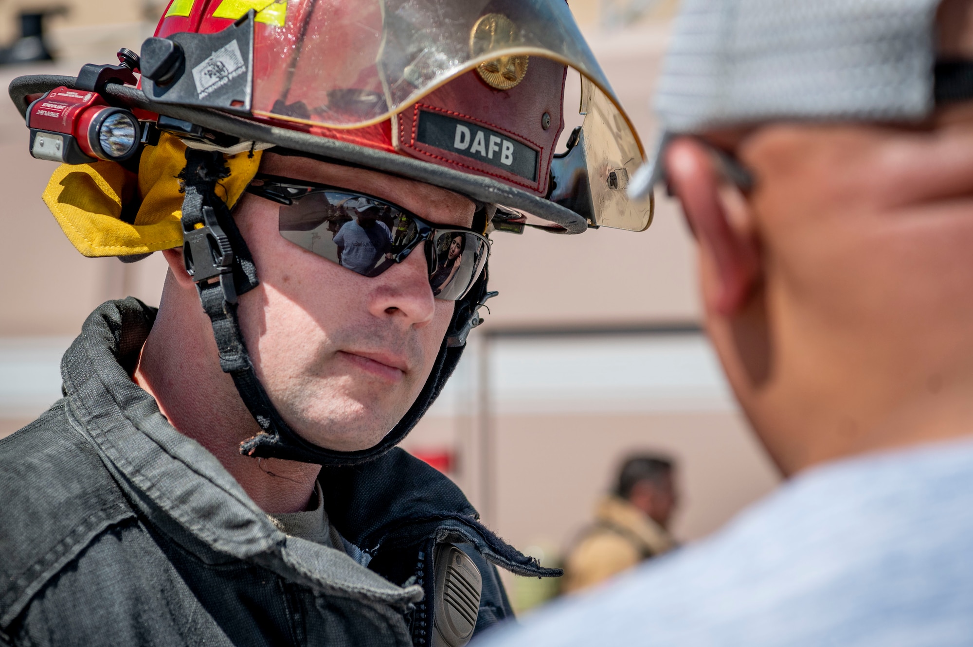 U.S. Air Force Tech Sgt. Nicholas Harrington, a 386th Civil Engineer Squadron firefighter, answers Kuwaiti newspaper journalist questions during Media Day at Ali Al Salem Air Base, Kuwait, March 21, 2023.