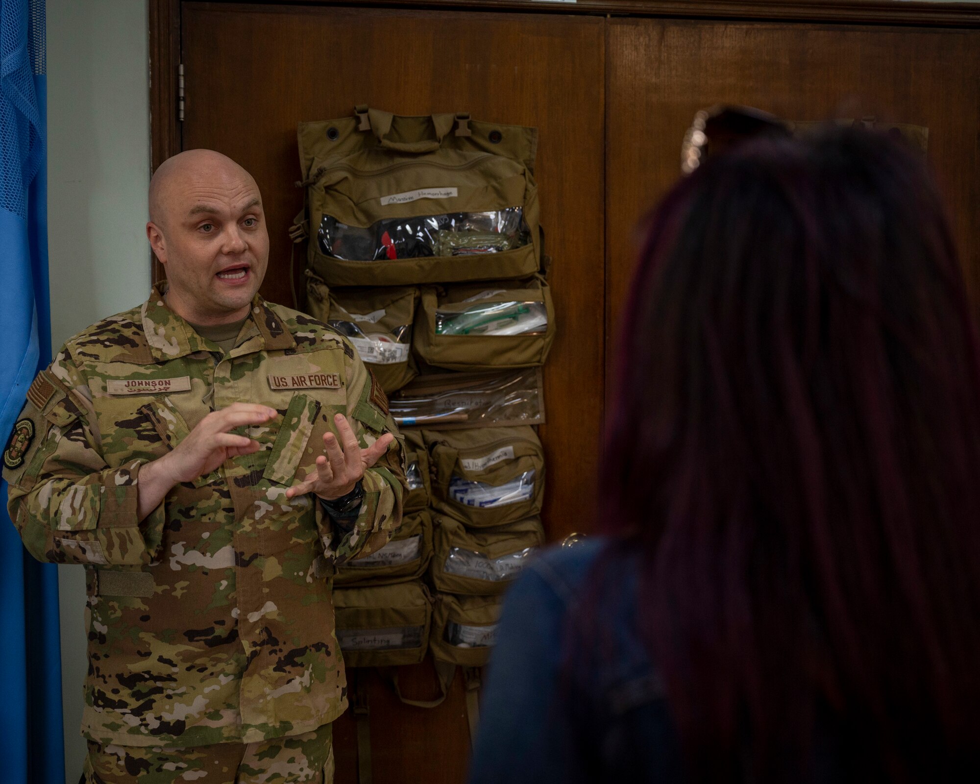 U.S. Air Force Maj. Jeremy Johnson, 386th Expeditionary Medical Squadron chief of medical staff, explains how Airmen take care of patients to Mai Alsoukari, Al Qabas journalist, at Ali Al Salem Air Base, Kuwait, March 21, 2023.