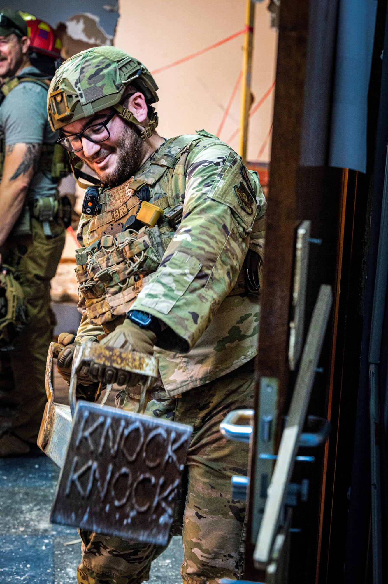 U.S. Air Force Senior Airman Noah Somers, 380th Expeditionary Security Forces Squadron member,  prepares to use a battering ram to break down a door in a building that is slated for demolition at Al Dhafra Air Base, United Arab Emirates, March 19, 2023. Defenders trained alongside 380th Expeditionary Civil Engineer Squadron firefighters and EOD Airmen to complete the realistic on-the-job training, using the unique opportunity of a location to train on to the full capacity. (U.S. Air Force photo by Staff Sgt. Sabatino DiMascio)