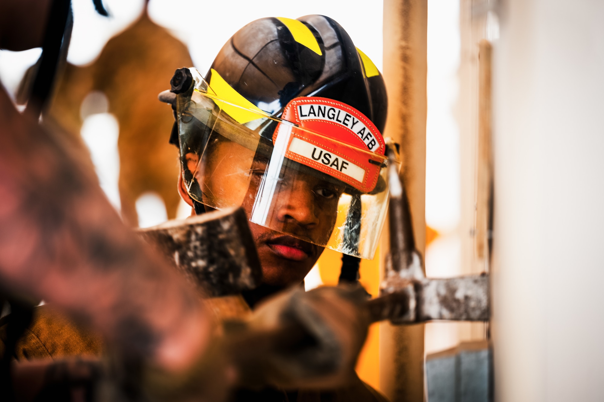 A U.S. Air Force Airman from the 380th Expeditionary Civil Engineer Squadron, Fire Emergency Services, uses a Halligan bar to forcibly open a door in a building that is slated for demolition at Al Dhafra Air Base, United Arab Emirates, March 19, 2023.  Firefighters and EOD Airmen trained alongside defenders from the 380th Expeditionary Security Forces Squadron to complete the realistic on-the-job training, using the unique opportunity of a location to train on to the full capacity. (U.S. Air Force photo by Staff Sgt. Sabatino DiMascio)