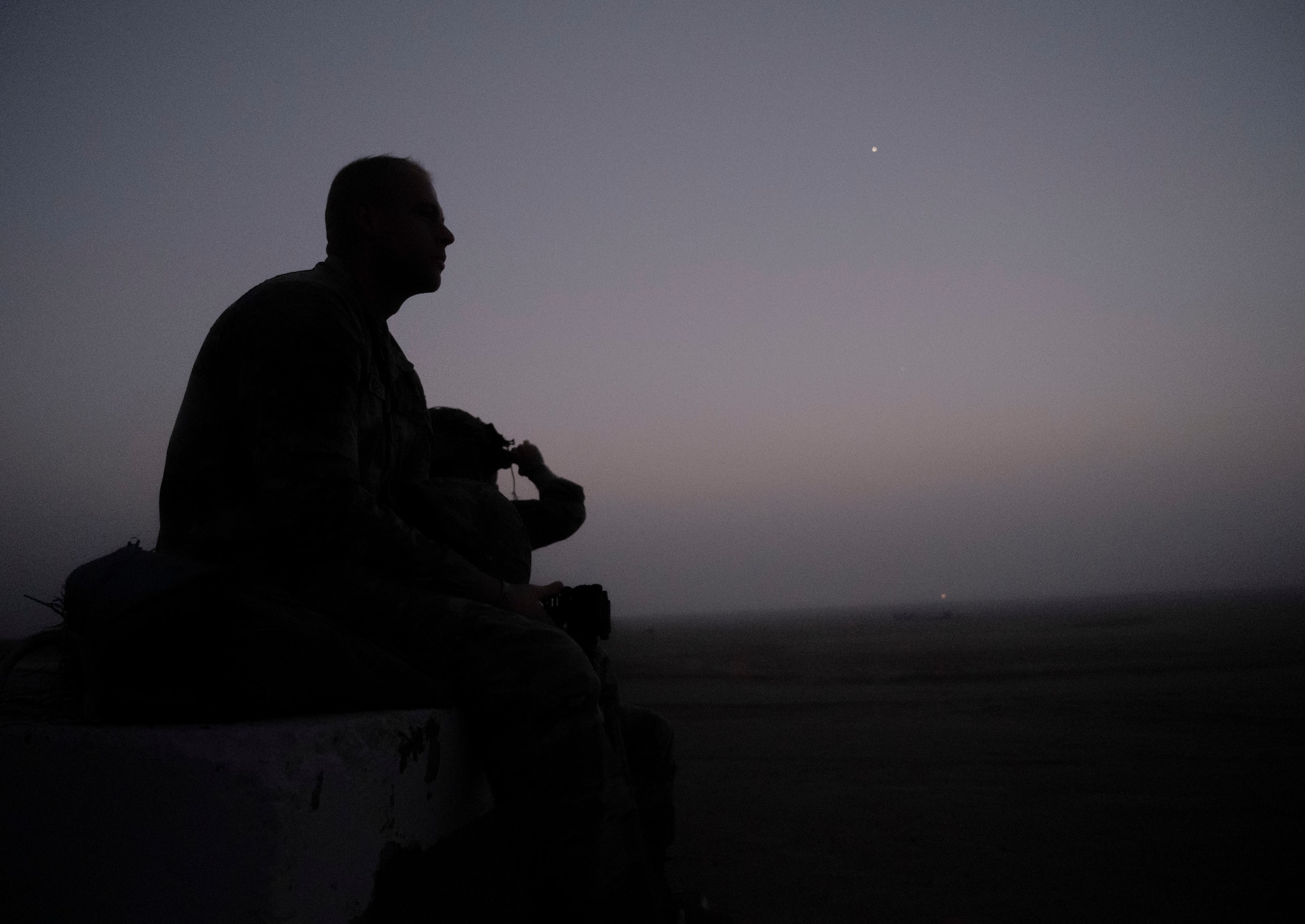 A U.S. Air Force Airman and a U.S. Army Soldier wait for tactical air controller party training to begin at the Udairi Range, Kuwait, March 14, 2023.