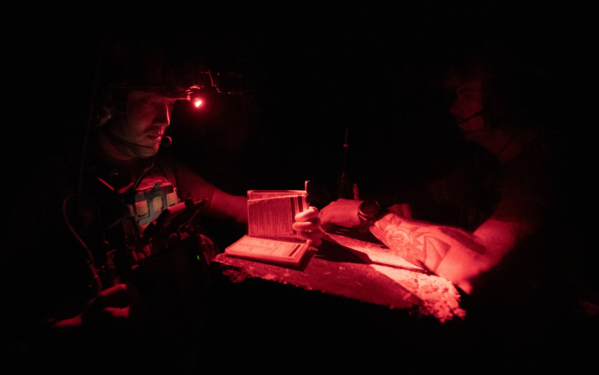 U.S. Air Force tactical air control party specialists from the 82nd Expeditionary Air Support Operations Squadron review procedures to call in fire support from an AC-130 during training at Udairi Range, Kuwait, March 14, 2023.