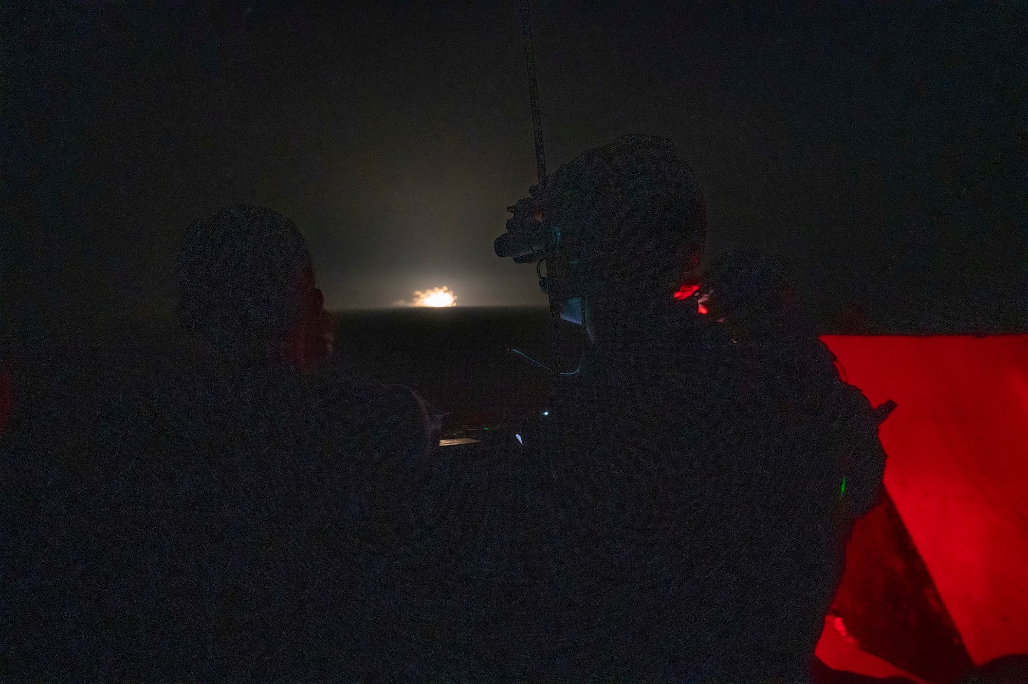 U.S. Air Force Airmen from the 82nd Expeditionary Air Support Operation Squadron tactical air control party watch as rounds from an AC-130 impact the target at Udairi Range, Kuwait, March 14, 2023.