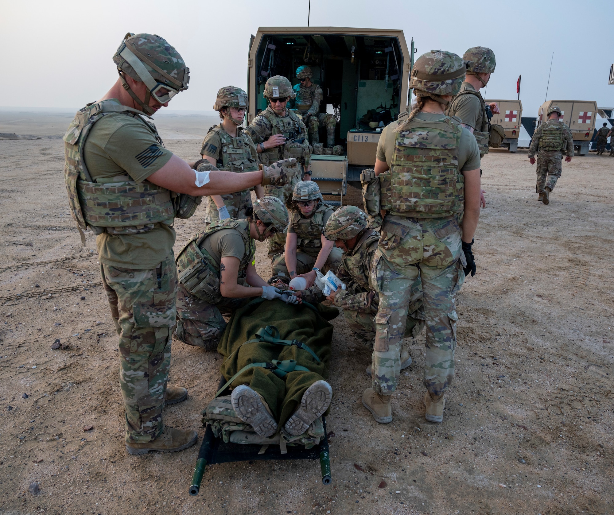 U.S. Army Soldiers prepare a patient for transport on a UH-60 Blackhawk helicopter at Udairi Range, Kuwait, March 14, 2023.