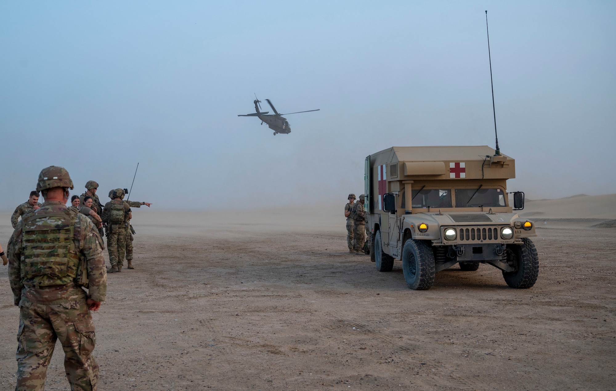 U.S. Army Soldiers watch as a UH-60 Blackhawk Helicopter takes off at Udairi Range, Kuwait, March 14, 2023.