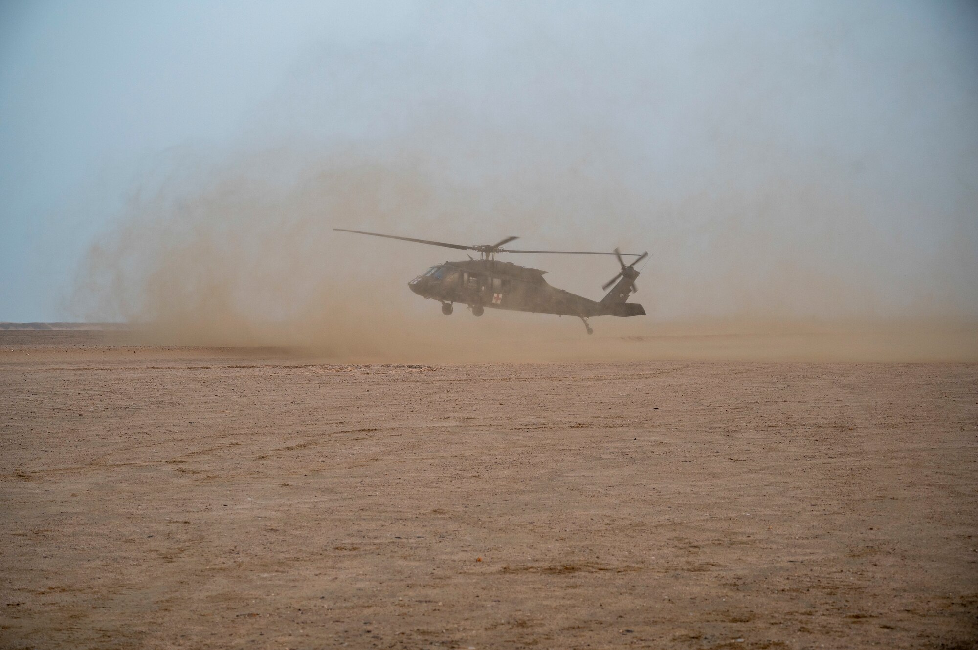 A UH-60 Blackhawk helicopter lands during medical evacuation training at Udairi Range, Kuwait, March 14, 2023.