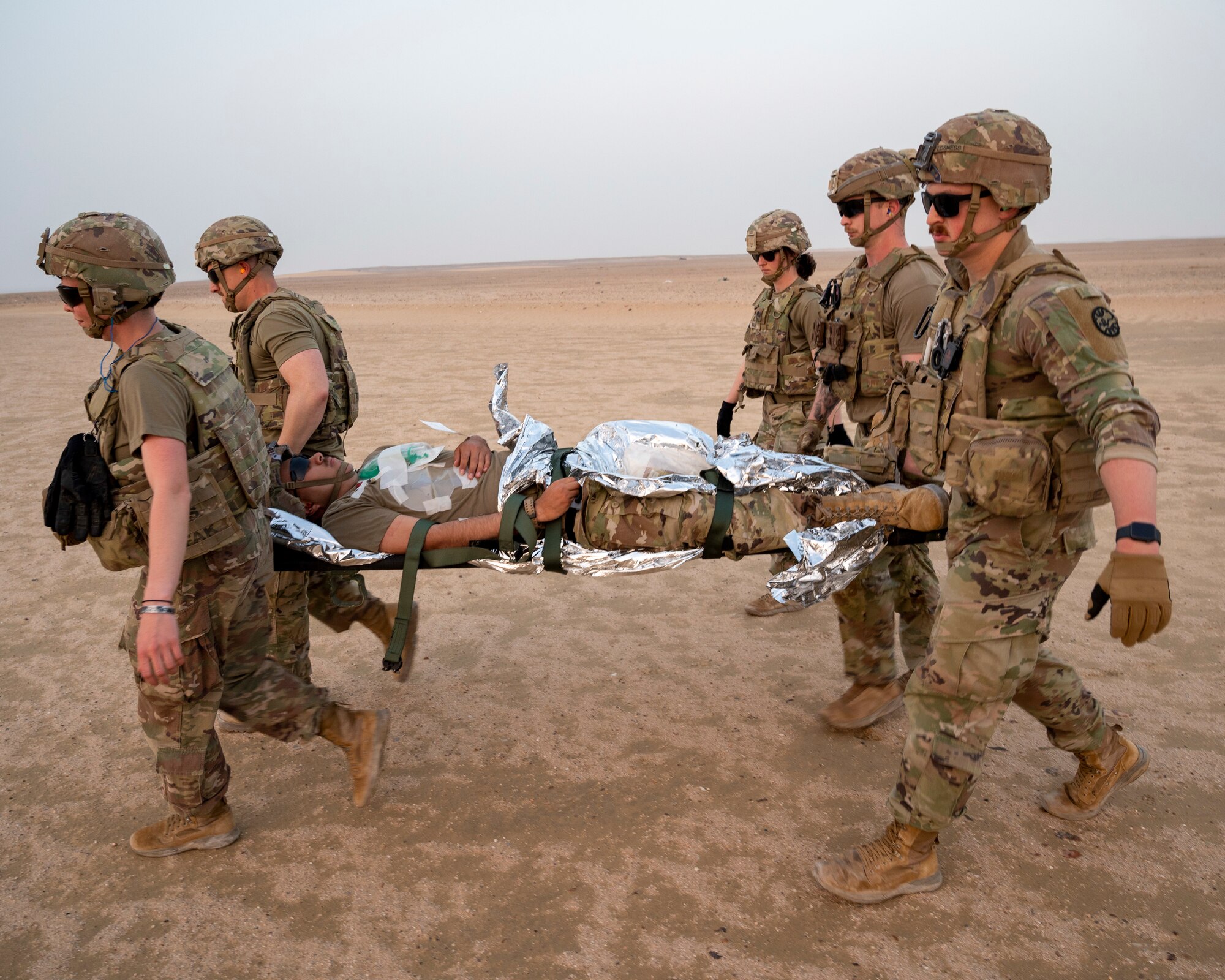 U.S. Army Soldiers move a patient on a litter during training at Udairi Range, Kuwait, March 14, 2023.