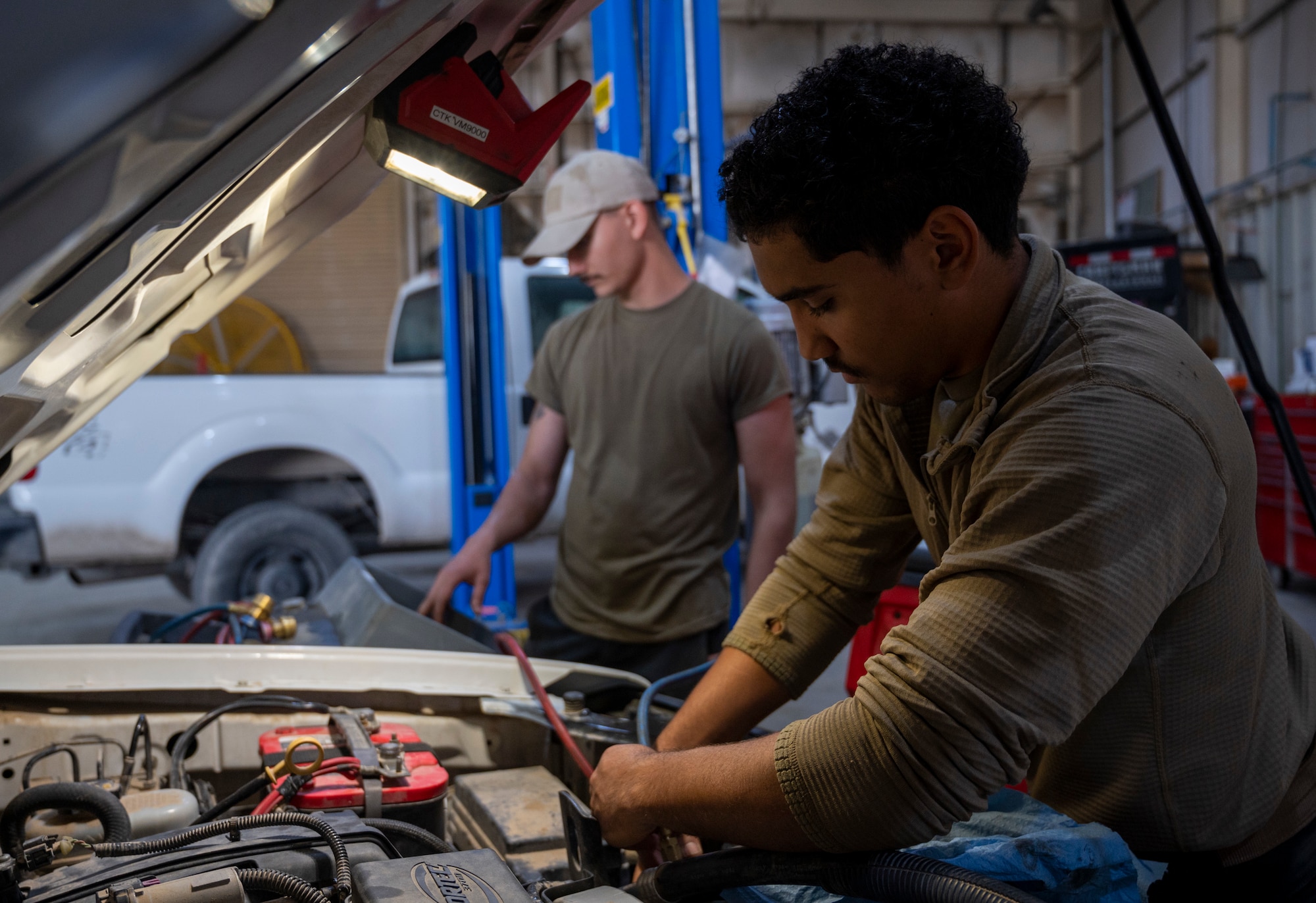 U.S. Air Force Airman 1st Class Gabriel Evans, a 386th Expeditionary Logistics Readiness Squadron vehicle management specialist, works on a truck at Ali Al Salem Air Base, Kuwait, March 8, 2023.