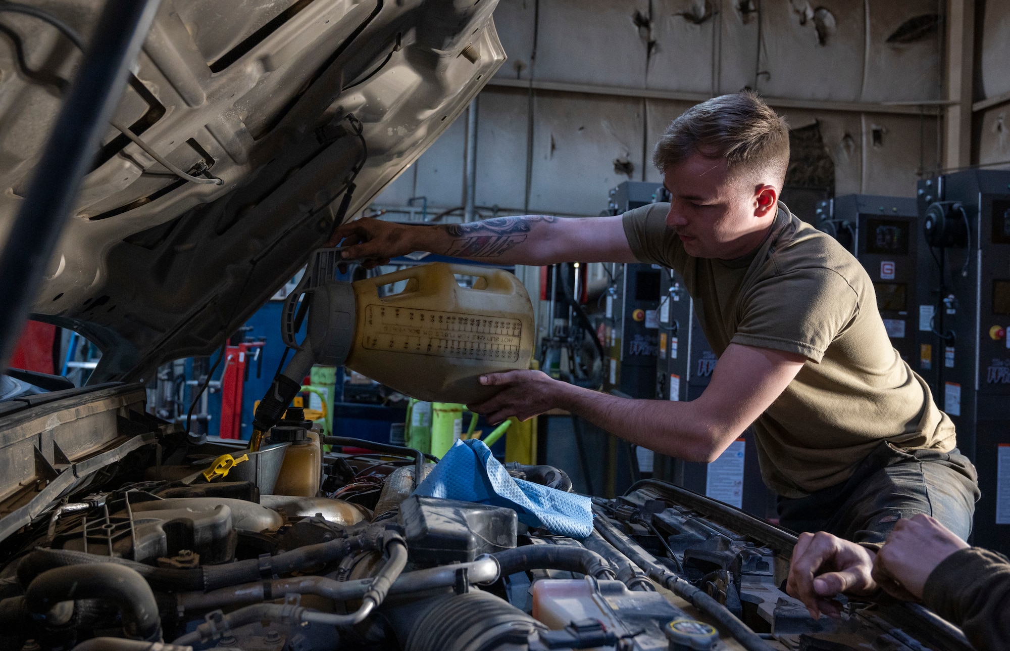 U.S. Air Force Airman 1st Class Chase Vancleave, a 386th Expeditionary Logistics Readiness Squadron vehicle management specialist, pours oil into a truck at Ali Al Salem Air Base, Kuwait, March 8, 2023.