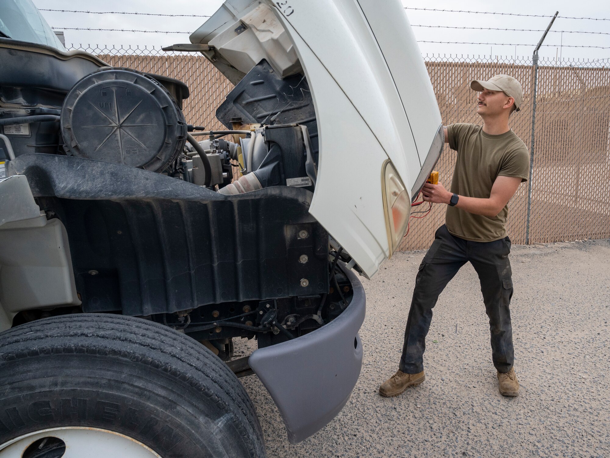 U.S. Air Force Airman 1st Class Kristopher Wilcott, a 386th Expeditionary Logistics Readiness Squadron vehicle management specialist, opens the engine bay of a wrecker at Ali Al Salem Air Base, Kuwait, March 8, 2023.