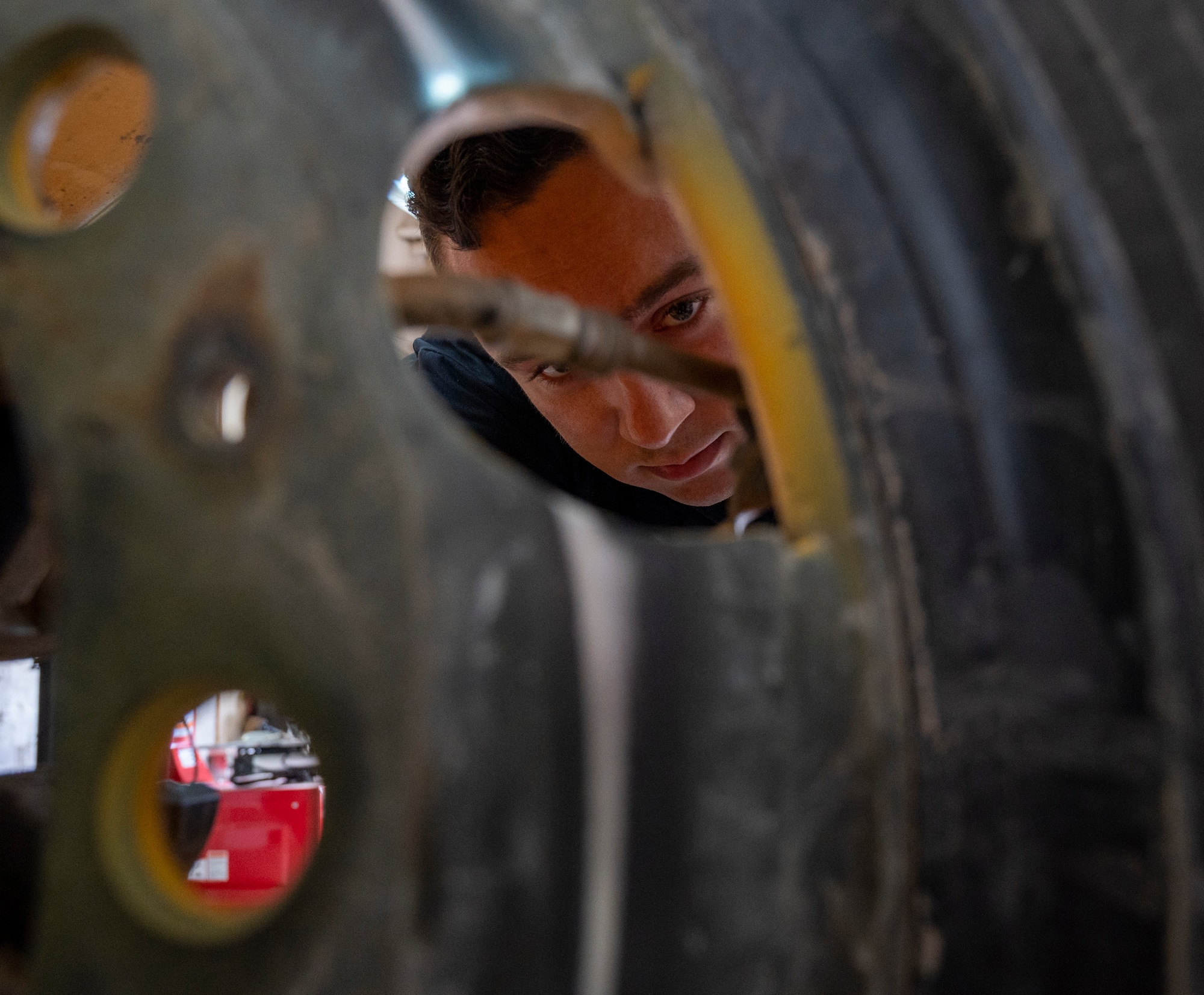 U.S. Air Force Staff Sgt. Kyle Reed-Mason, 386th ELRS vehicle management specialist, inspects a tire at Ali Al Salem Air Base, Kuwait, March 8, 2023.